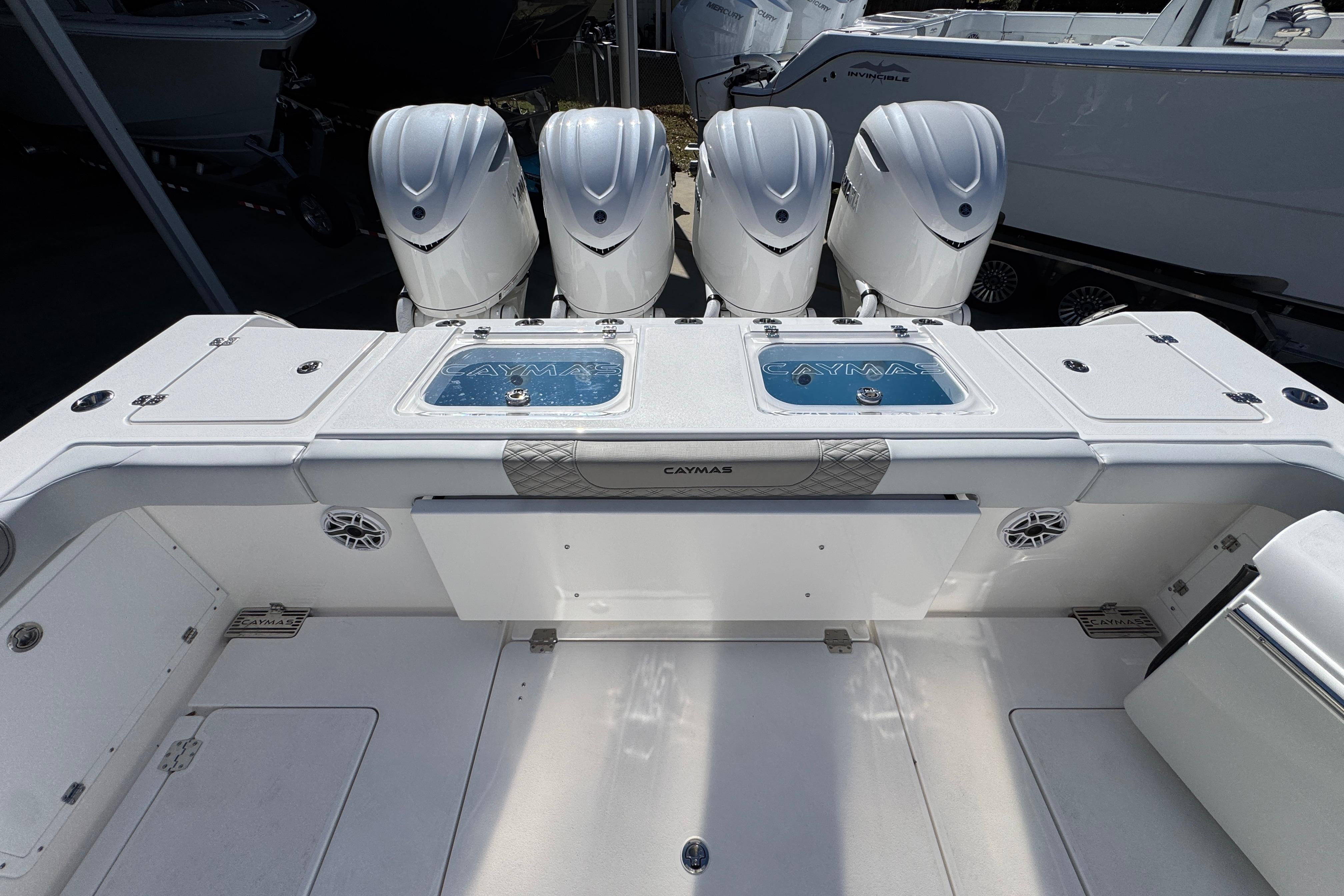 2027 Caymas 401 CC boat with four powerful outboard engines, sleek design, and spacious deck.
