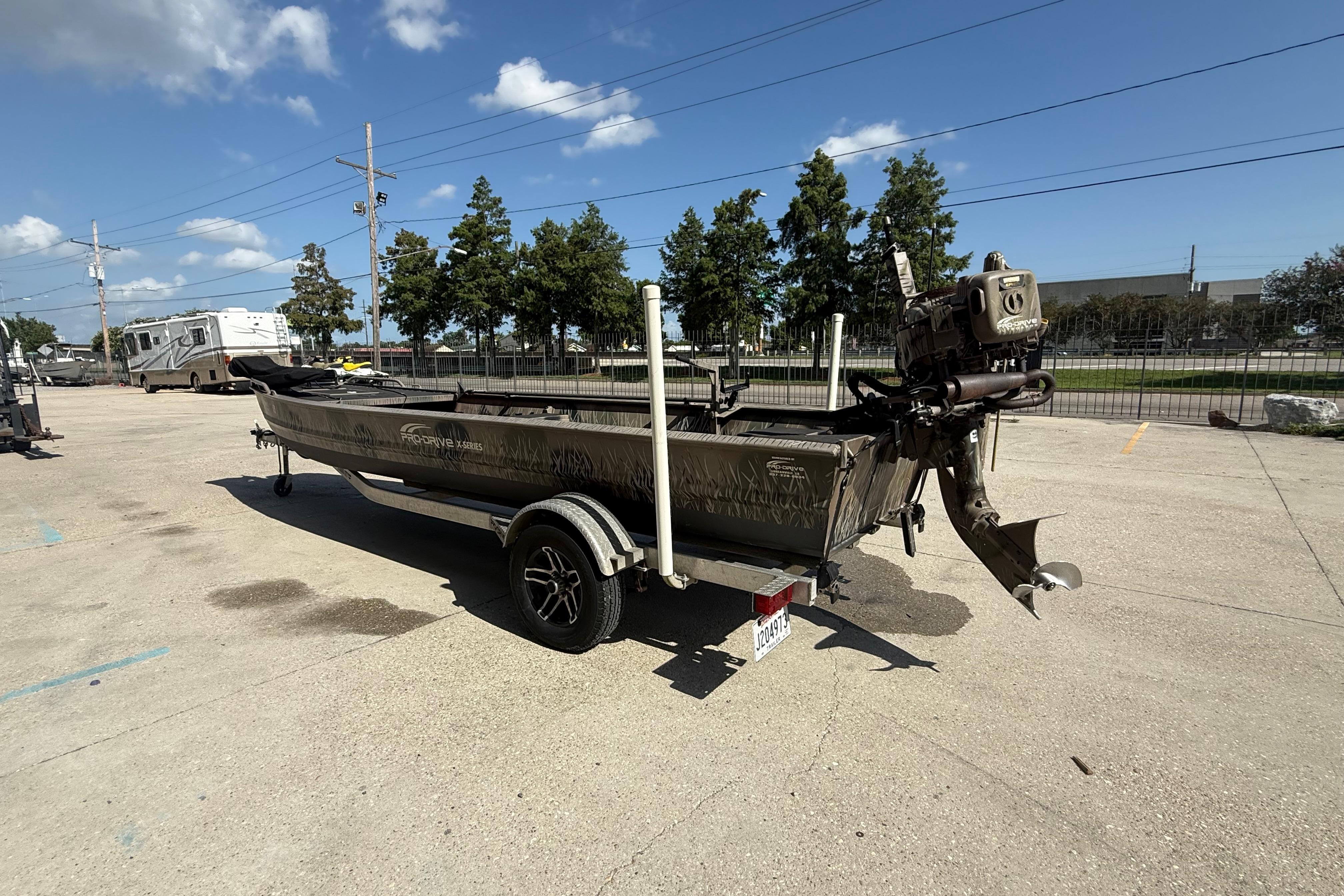 2017 Pro-Drive 2048 boat on trailer in parking lot under clear sky.