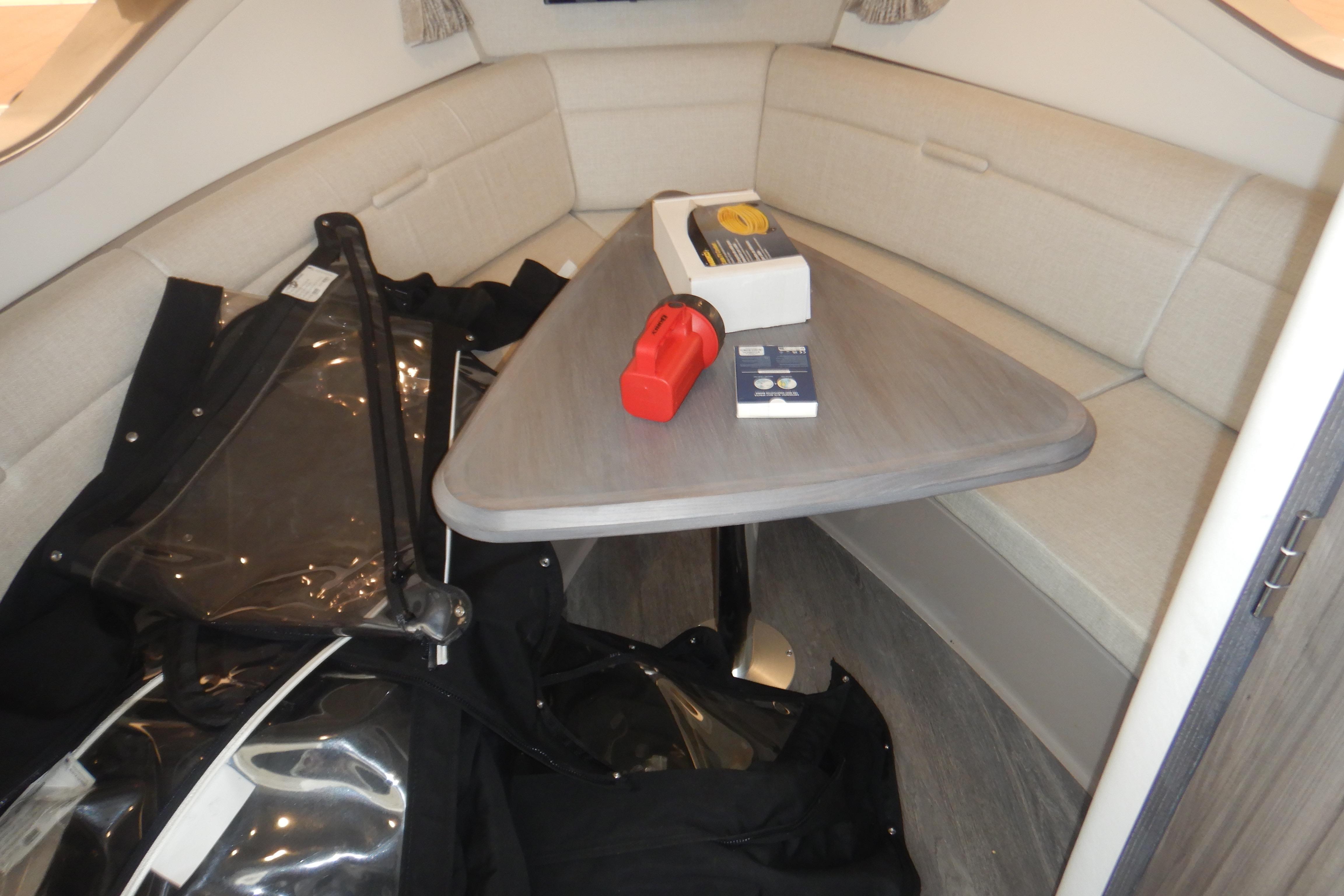 2023 Sea Ray Sundancer 320 cabin interior with table and seating area.