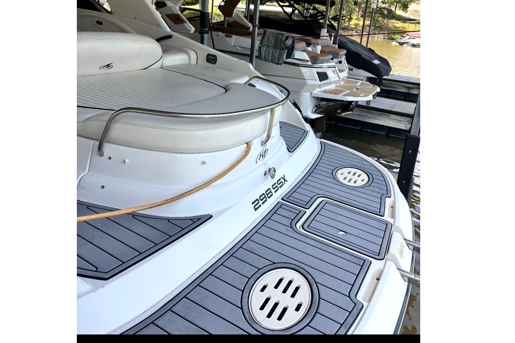 2007 Monterey 298SSX Super Sport boat docked, featuring sleek design and spacious seating.