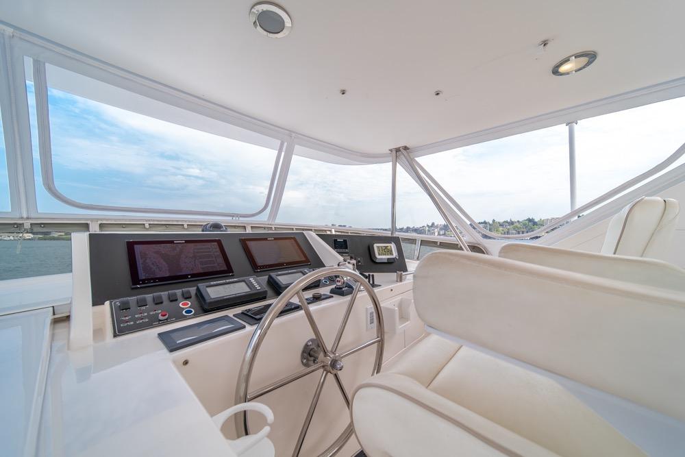 Helm of 2005 Ocean Alexander 64 Motoryacht with modern navigation equipment and panoramic views.