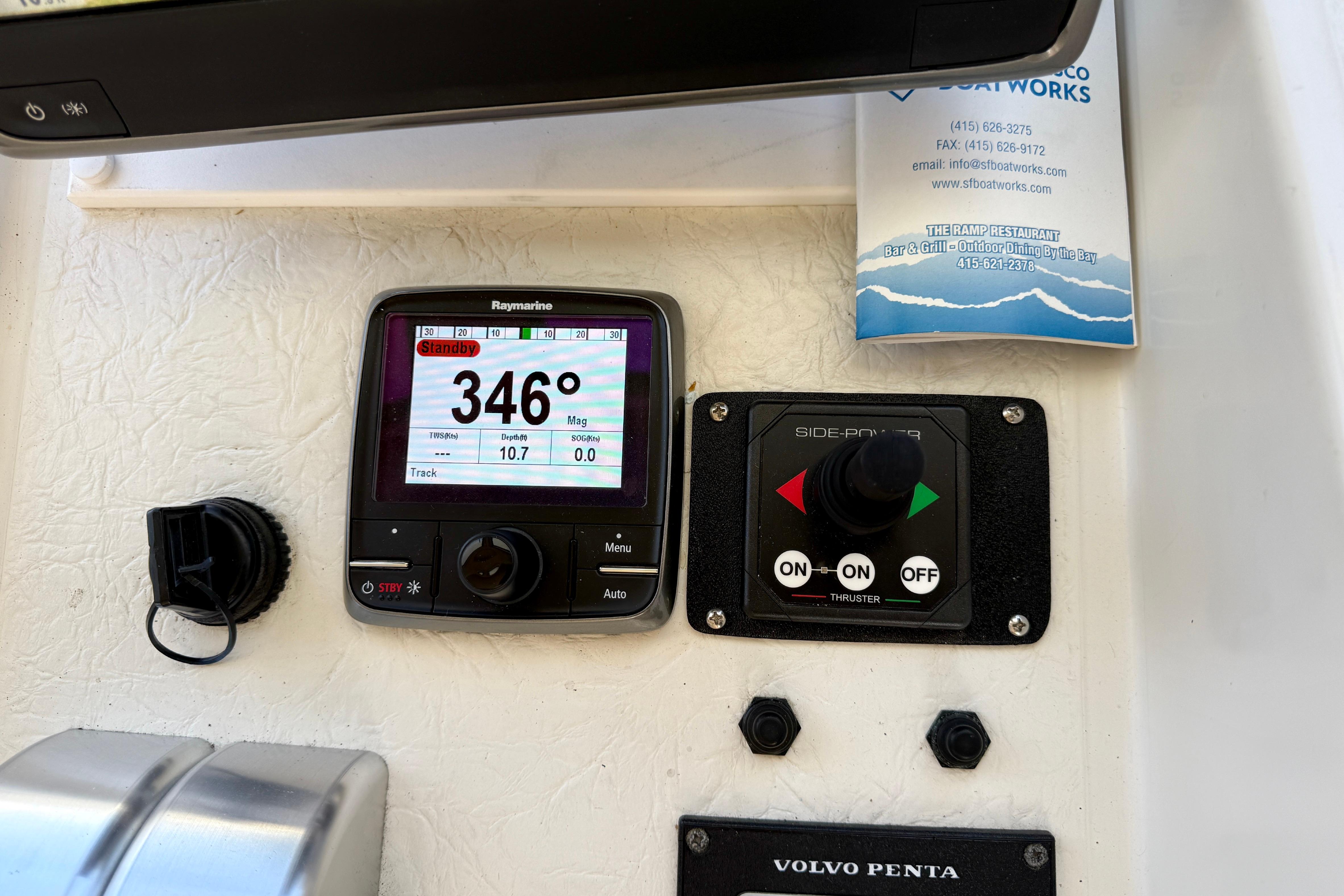 Boat navigation controls with Raymarine display, thruster panel, and Volvo Penta branding, Navigator Pilothouse 1997.