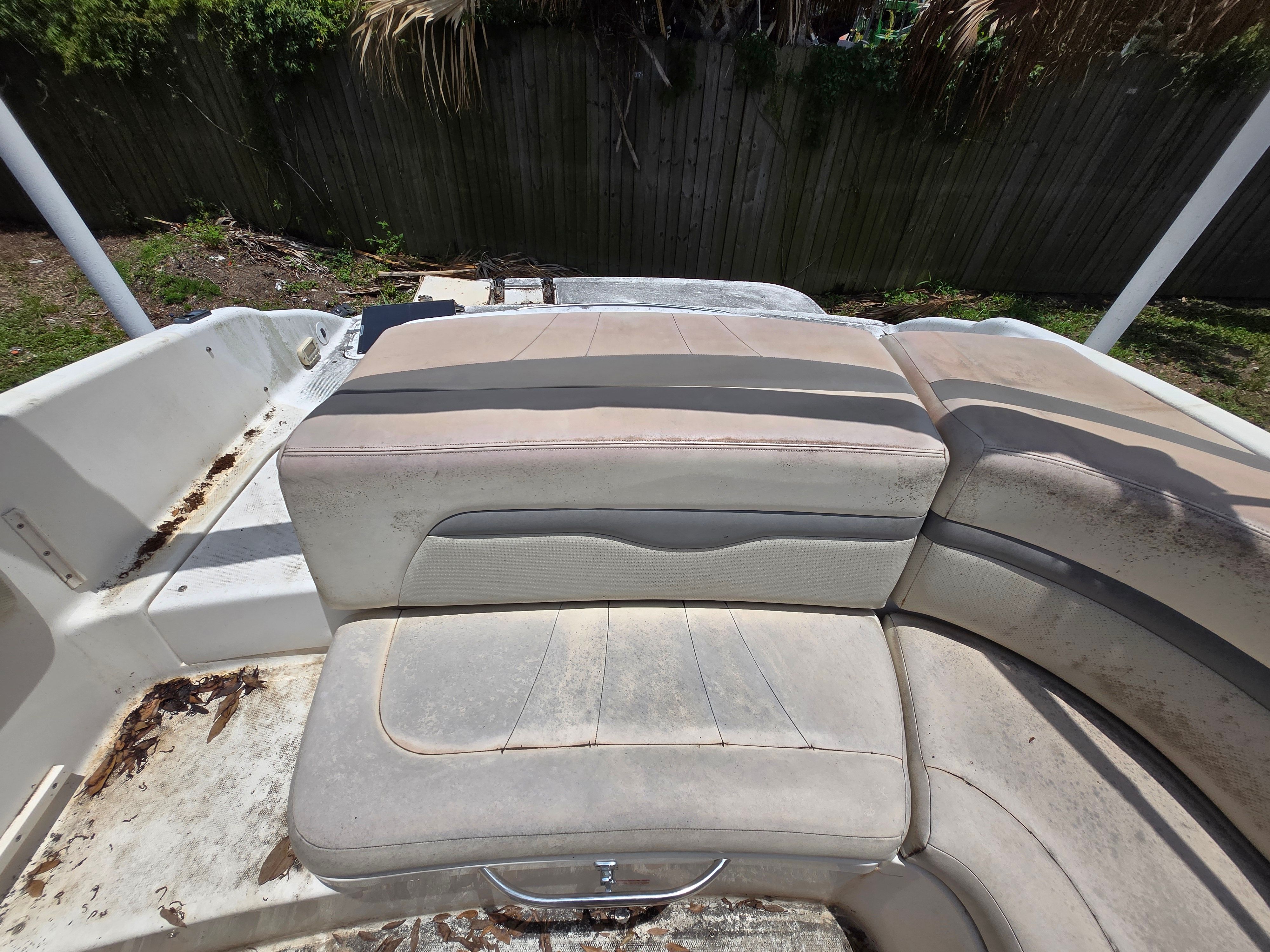 The image shows the worn seating of a 2006 Chaparral 220 SSi boat.