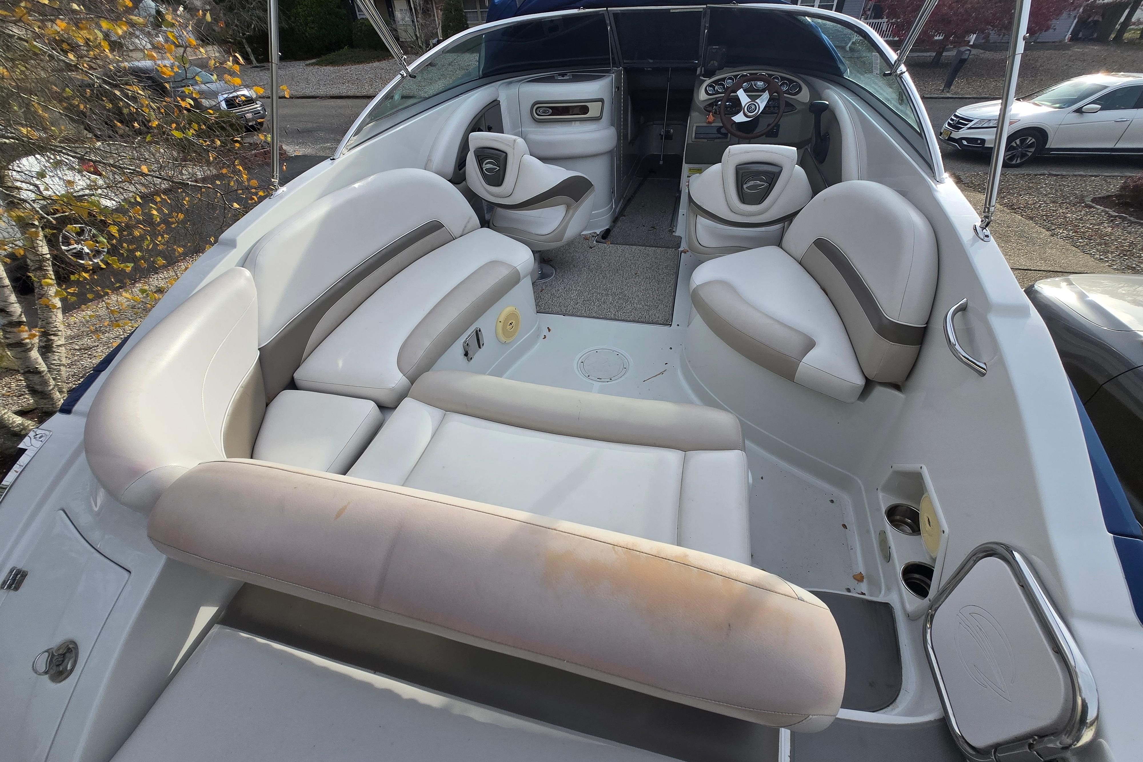 2012 Crownline Eclipse E4 boat interior with white seating and steering console.