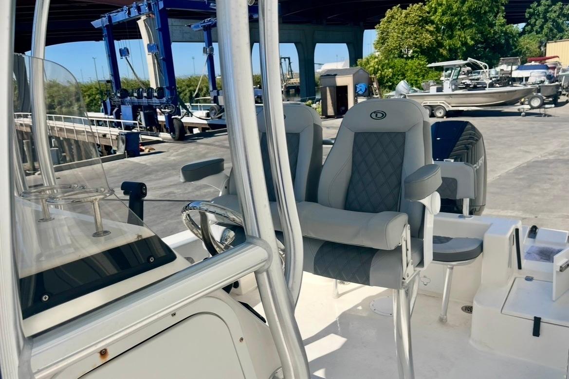 2025 Defiance Catalina 240 boat interior with modern seating and steering wheel.