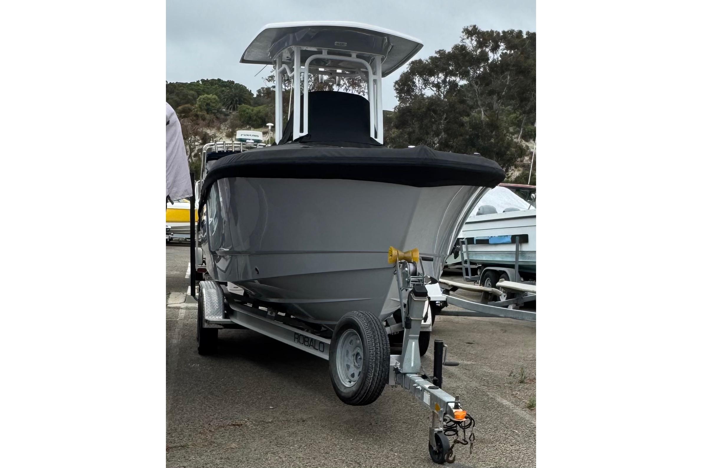 2022 Robalo R230 Center Console boat on trailer, parked outdoors.