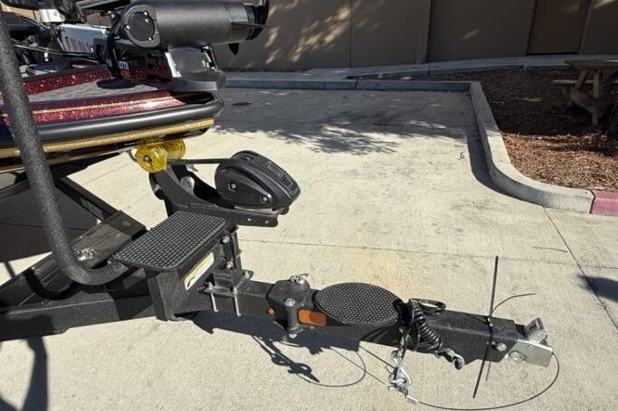Trailer hitch of a 2026 Nitro Z21 XL Pro boat on concrete pavement.