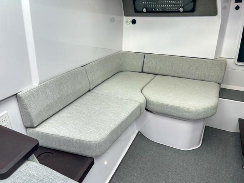 2024 Axopar 37 Sun Top interior seating area with grey cushions.