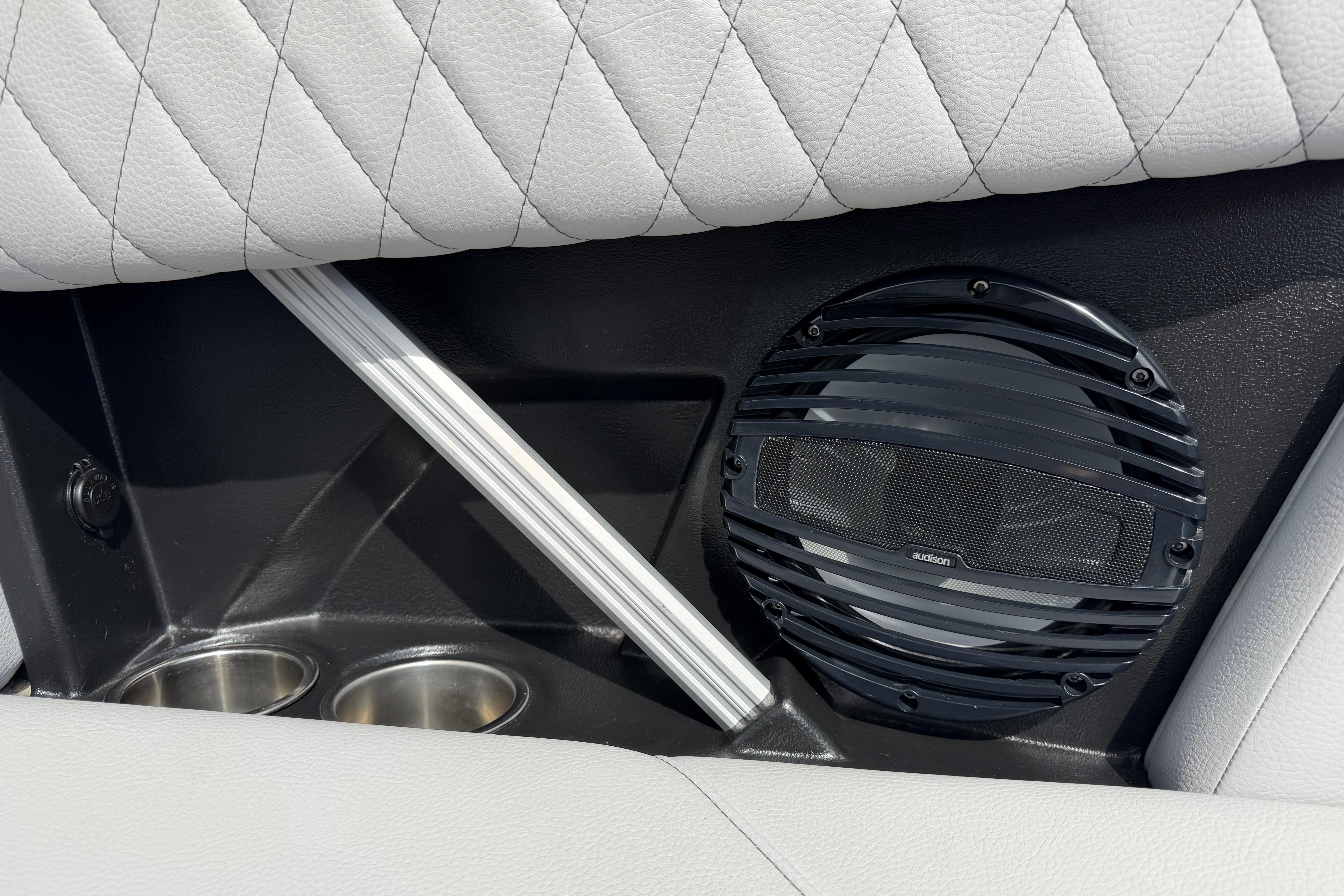 2024 Tigé Z1 interior with speaker, cup holders, and quilted upholstery.
