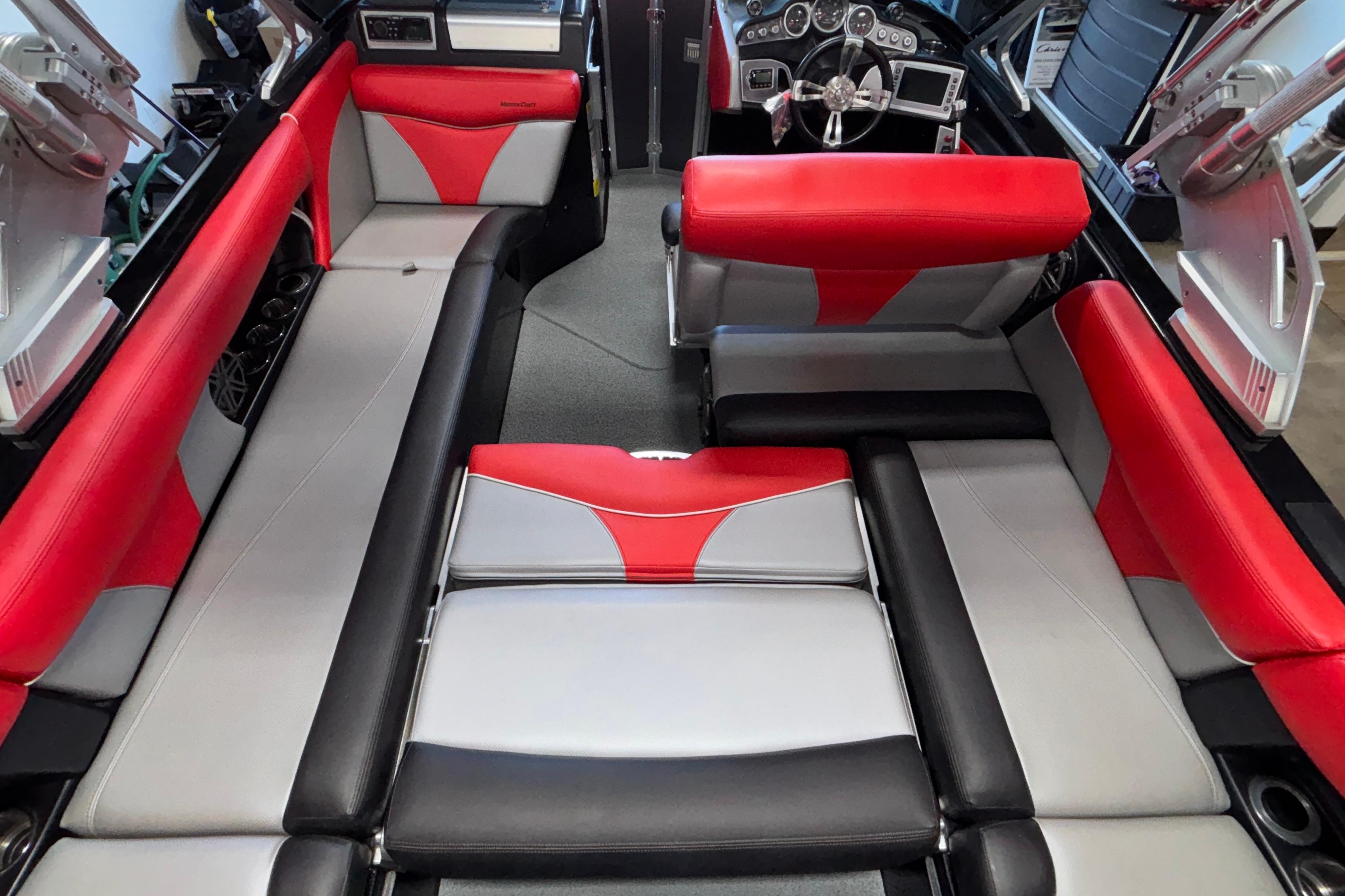 2017 MasterCraft X46 interior with red and gray seating, modern dashboard, and spacious layout.