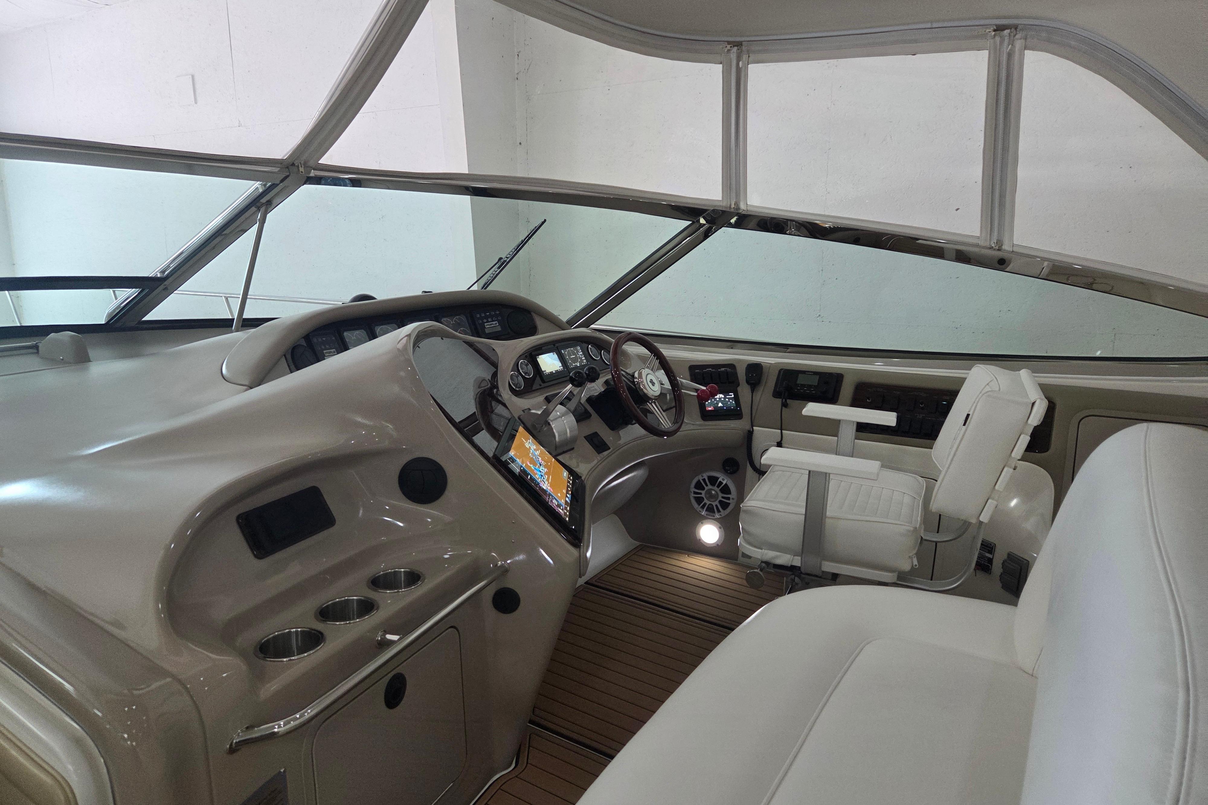 Interior cockpit of 2000 Sea Ray Sundancer 540 yacht with modern controls and seating.
