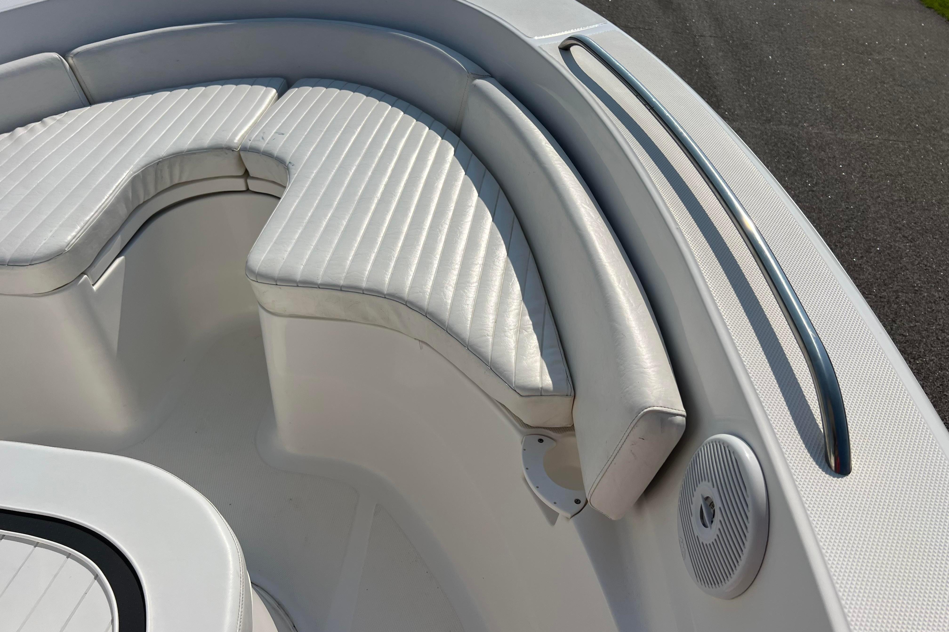 2012 Sea Fox 206 Center Console boat with white cushioned seating and stainless steel rail.