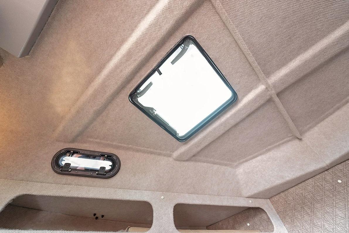 Interior ceiling view of 2026 KingFisher 3225 GFX Offshore boat with hatch and light fixture.