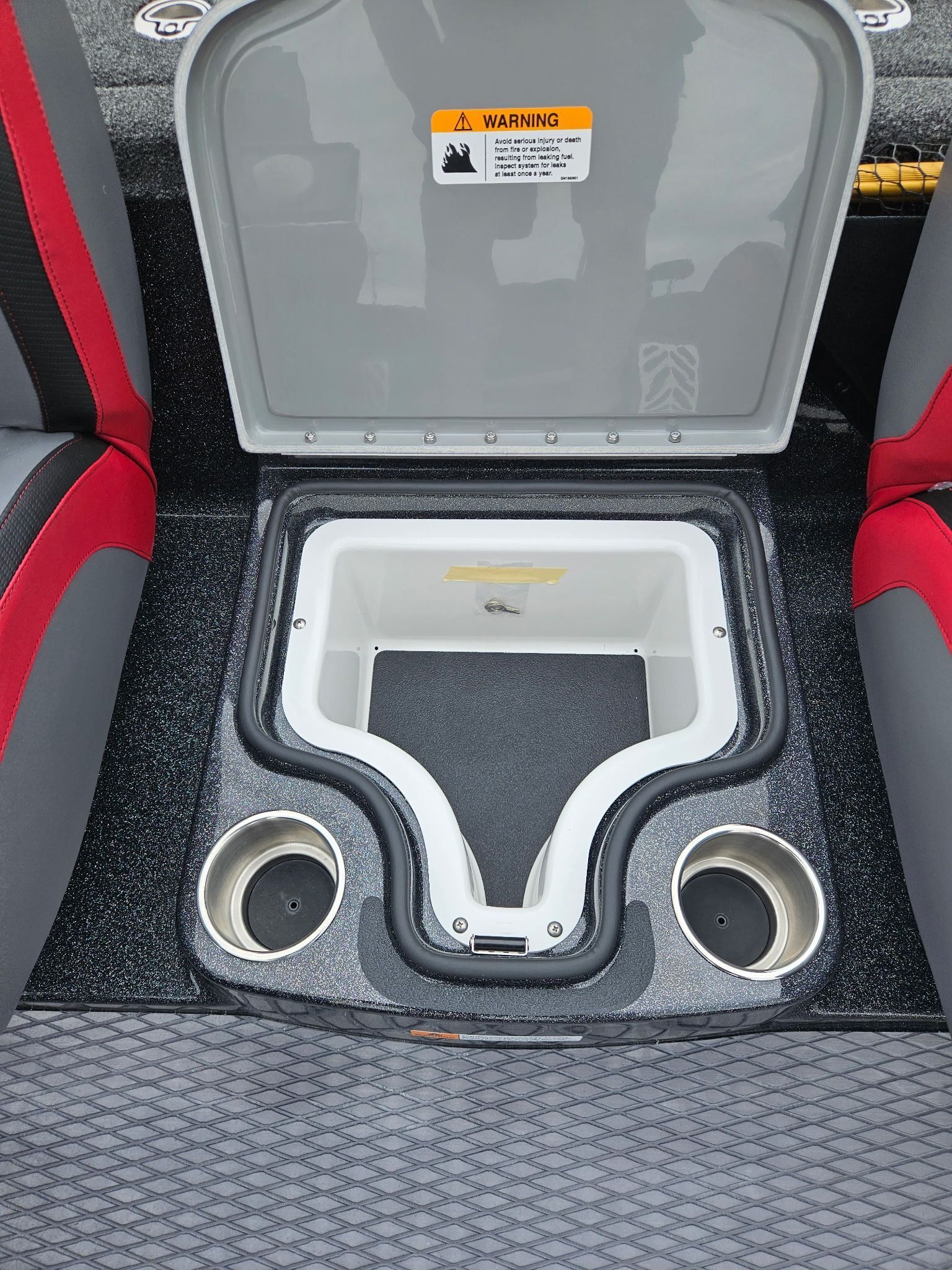 Caymas CX 21 PRO 2027 boat interior with storage compartment and cup holders.