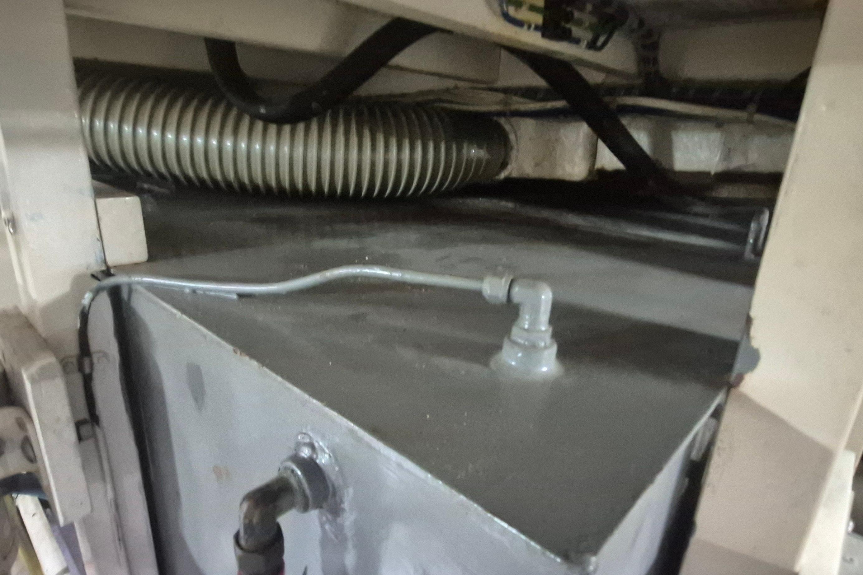 Engine compartment of a 1983 Grand Banks 42 Motoryacht, showing pipes and fittings.