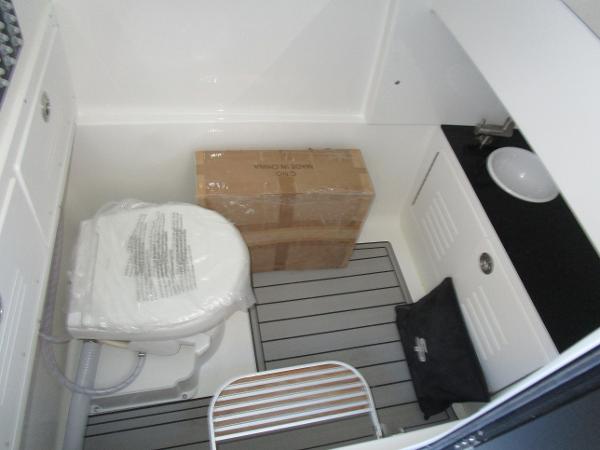 2025 Sea Pro 292 Offshore boat interior with toilet and storage area.