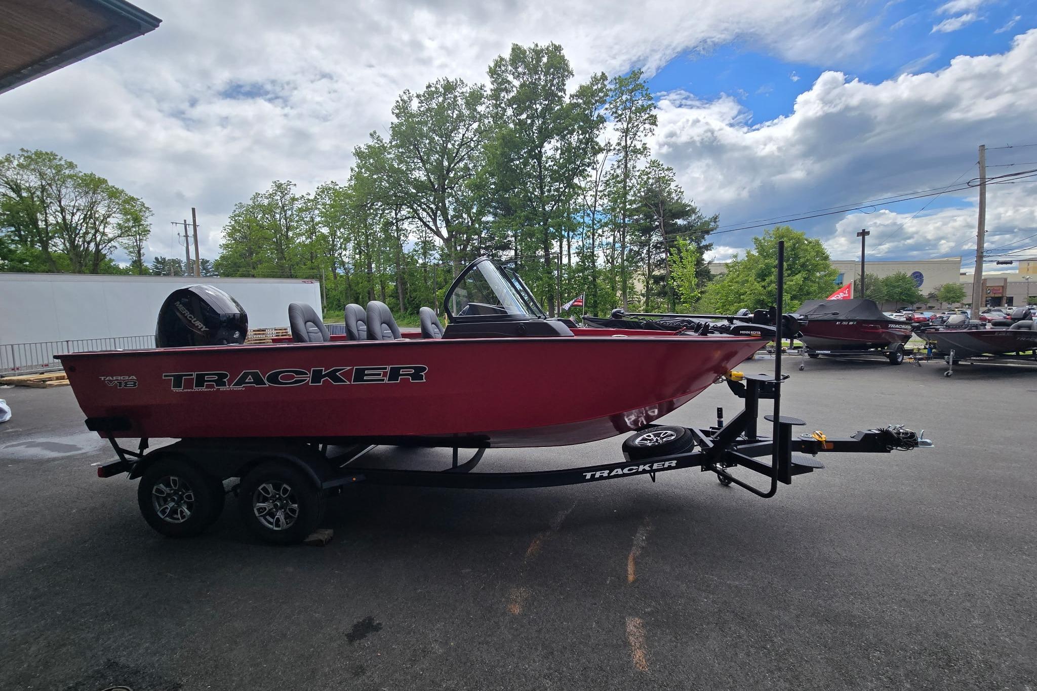 2026 Tracker Targa V-18 WT boat on trailer, parked outdoors under cloudy sky.