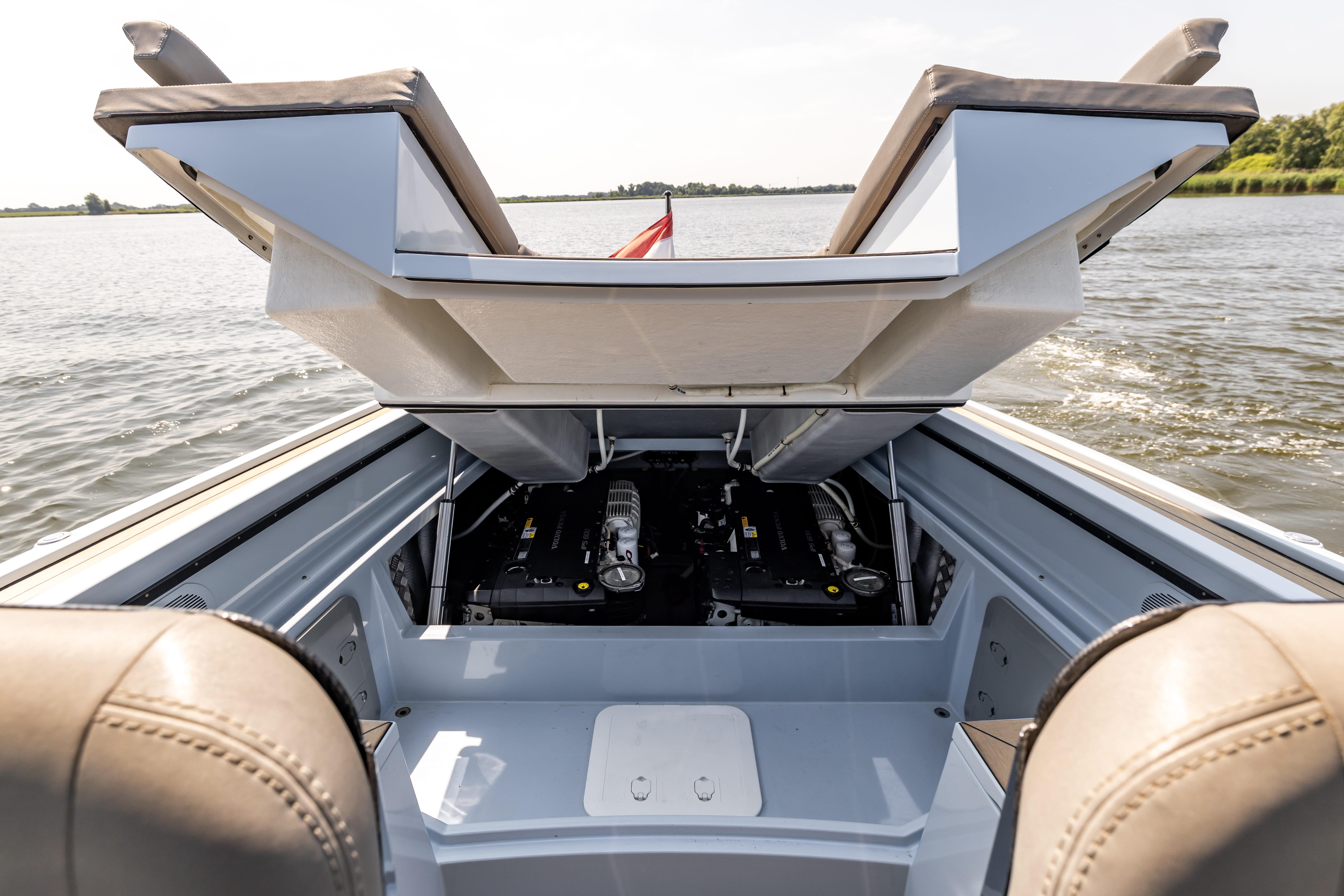 2017 Wajer 38 boat engine compartment open on a calm lake.
