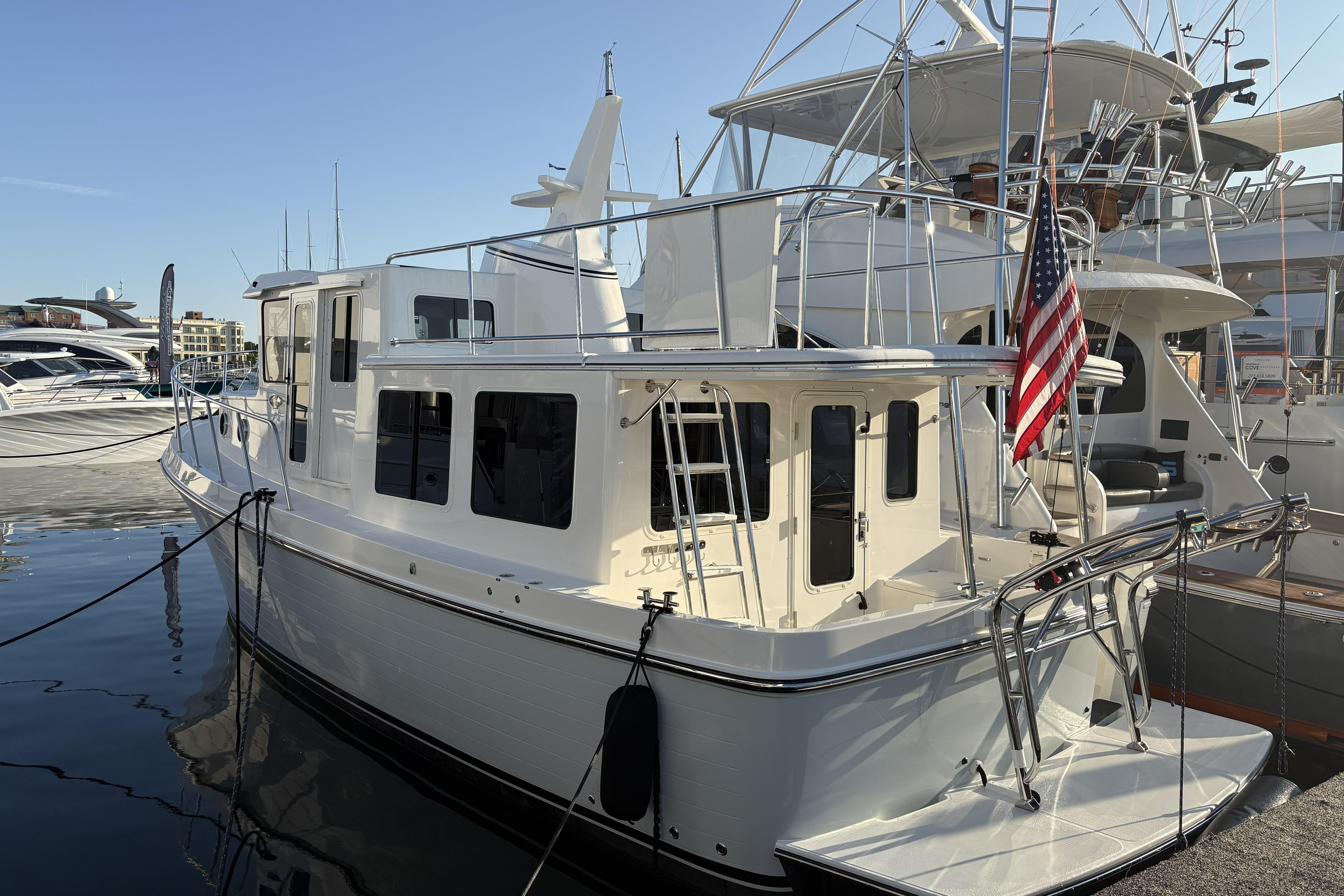 2026 American Tug 362 docked at marina with American flag displayed.