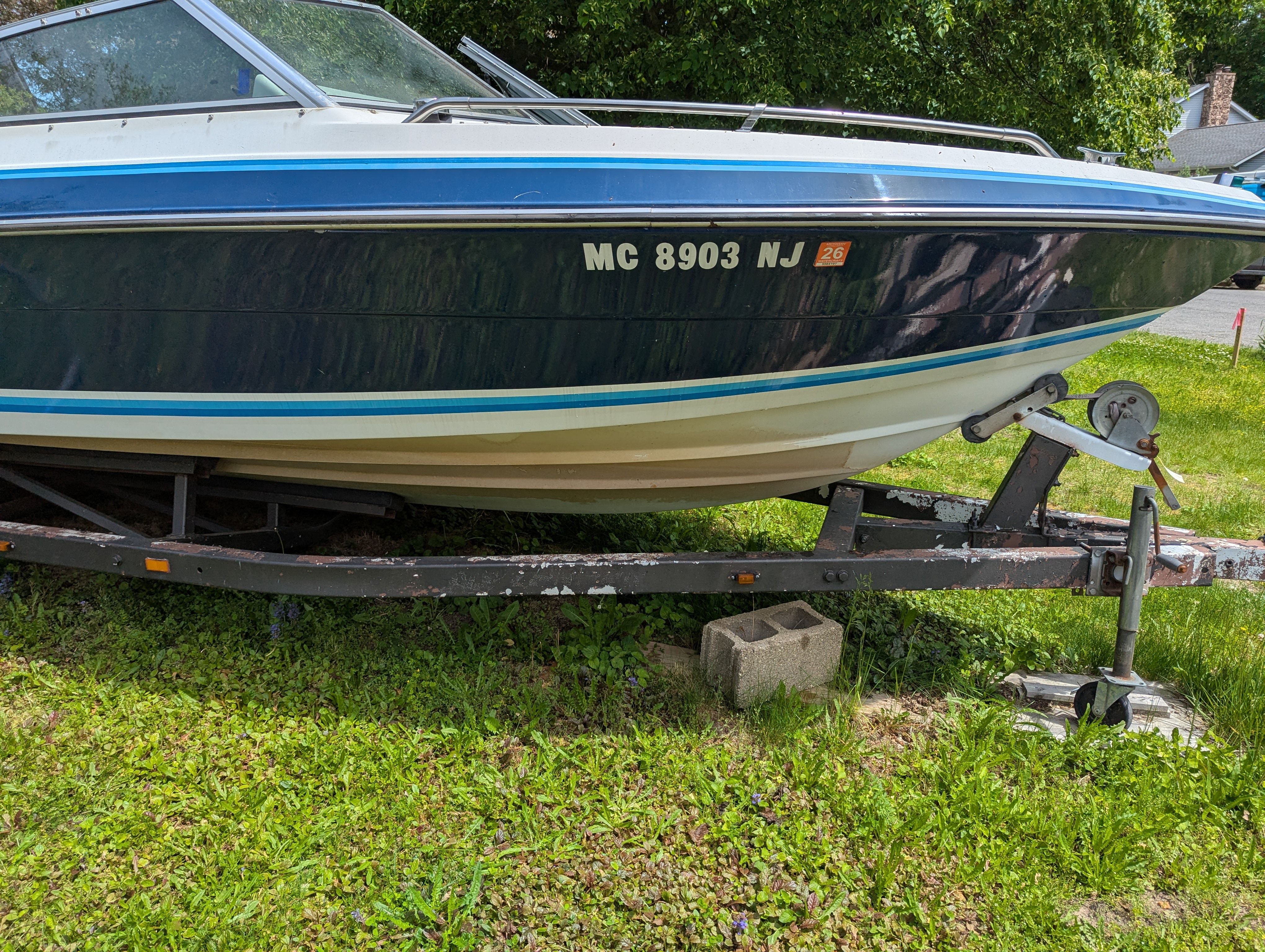 1988 Four Winns 200 Horizon boat on trailer outdoors.