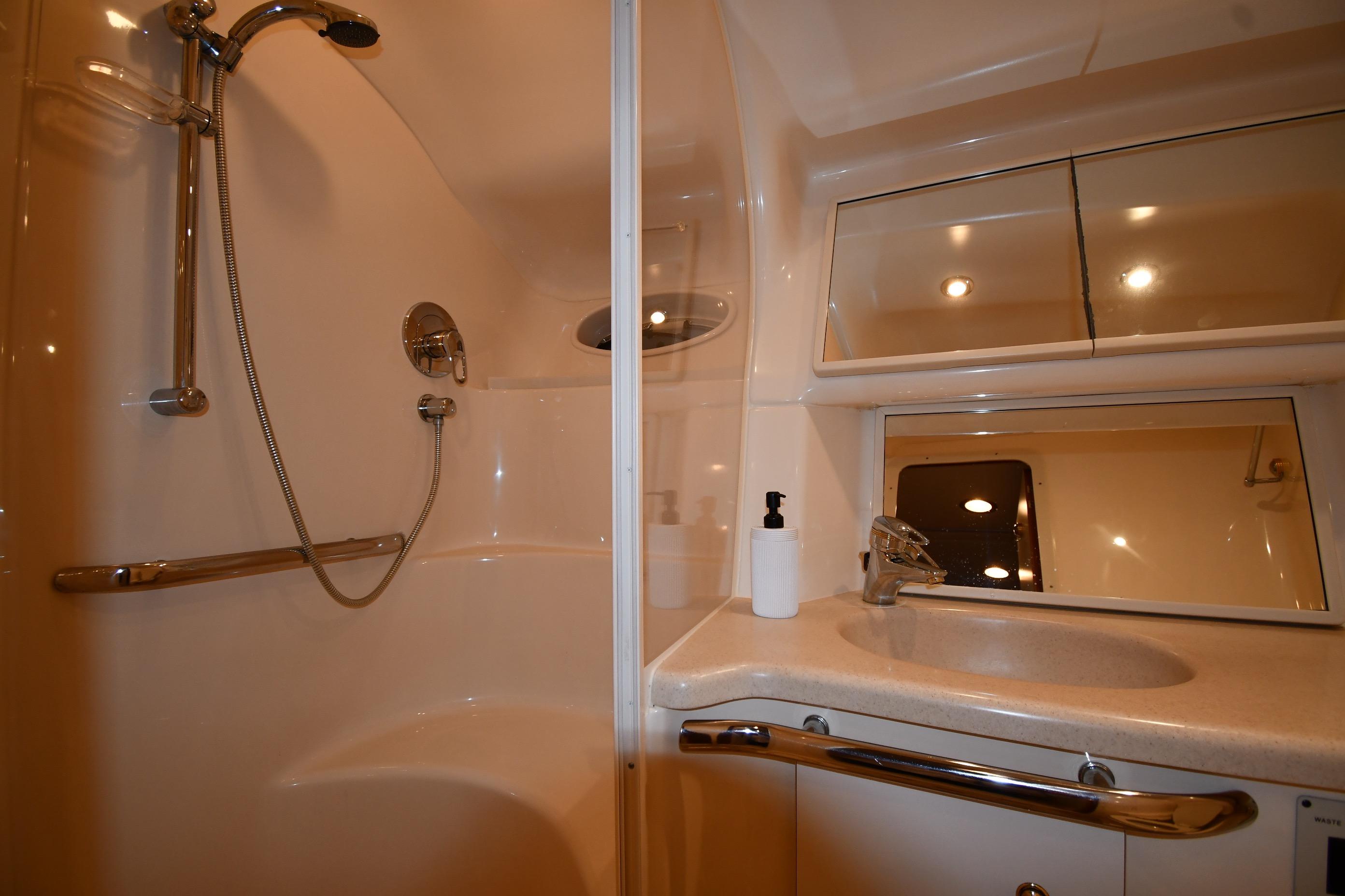 Luxurious bathroom in 2001 Sea Ray 540 Sundancer yacht with shower and vanity.