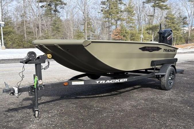 2026 Tracker Grizzly 1650 T Prairie Wings Edition boat on trailer, parked outdoors.