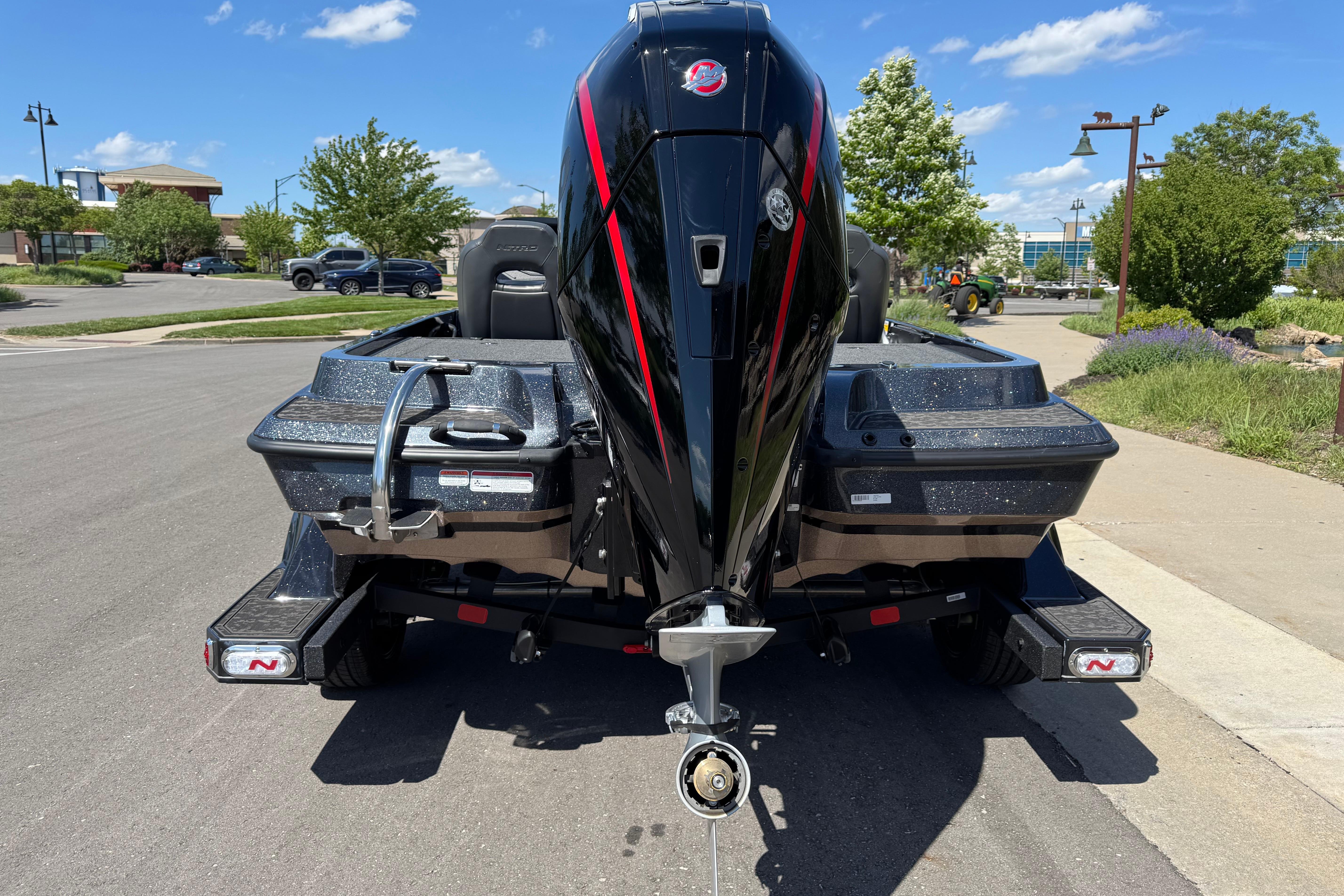 2026 Nitro Z19 XL boat with powerful outboard motor, parked on a sunny street.