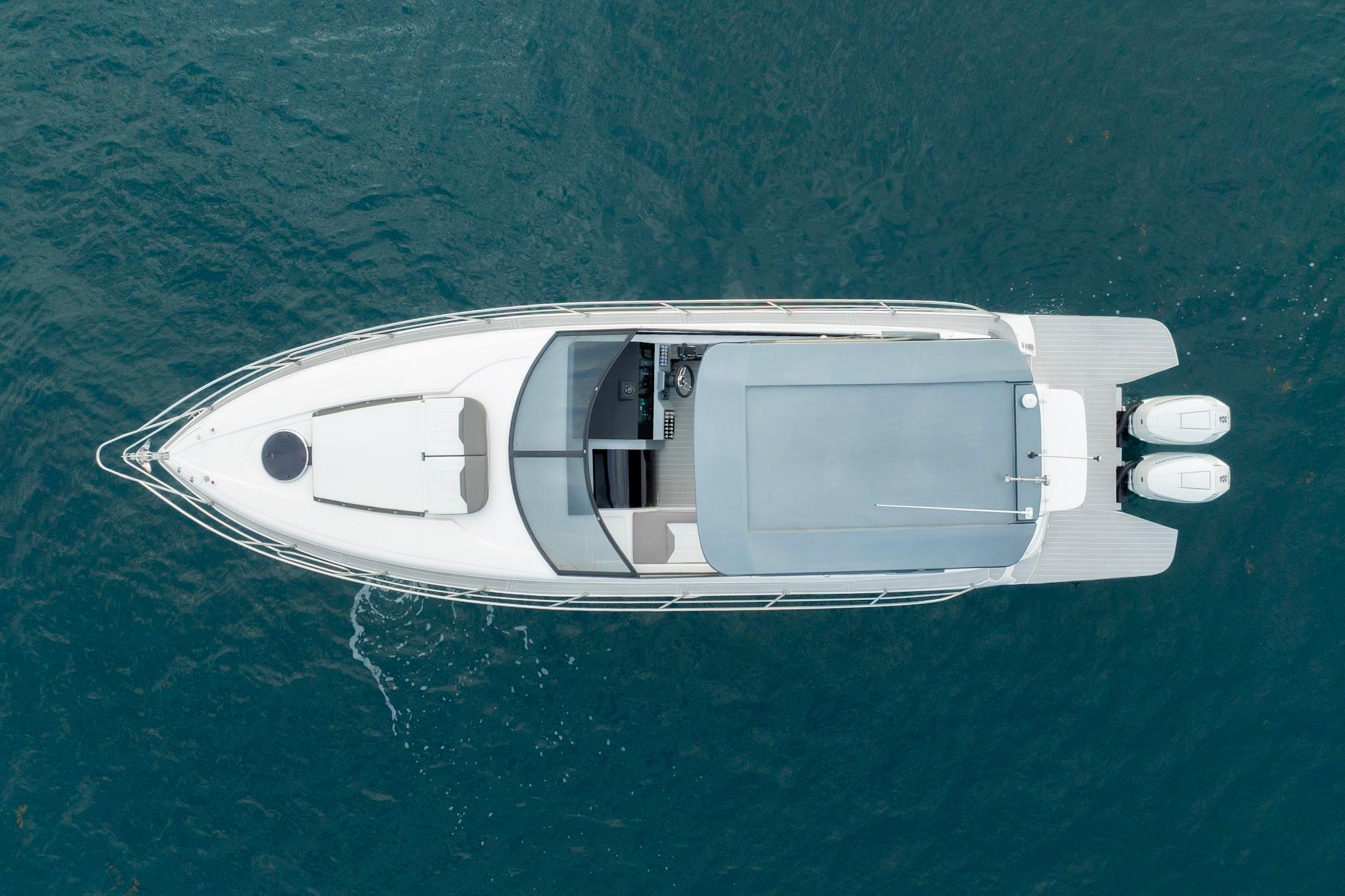 Aerial view of 2025 Valiatt 380GT luxury boat on blue water.