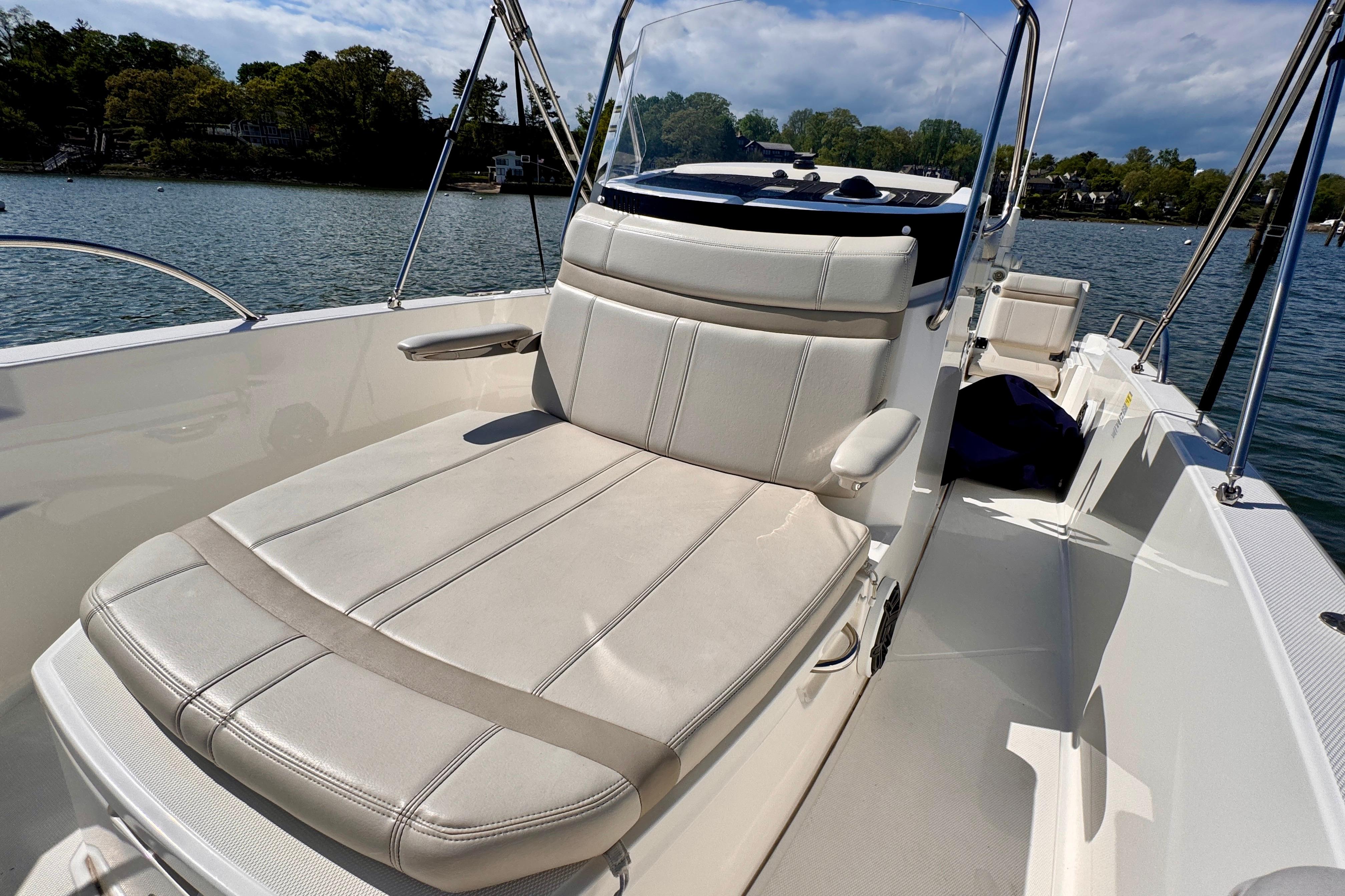 2022 Boston Whaler 220 Dauntless boat interior with comfortable seating on a sunny day.
