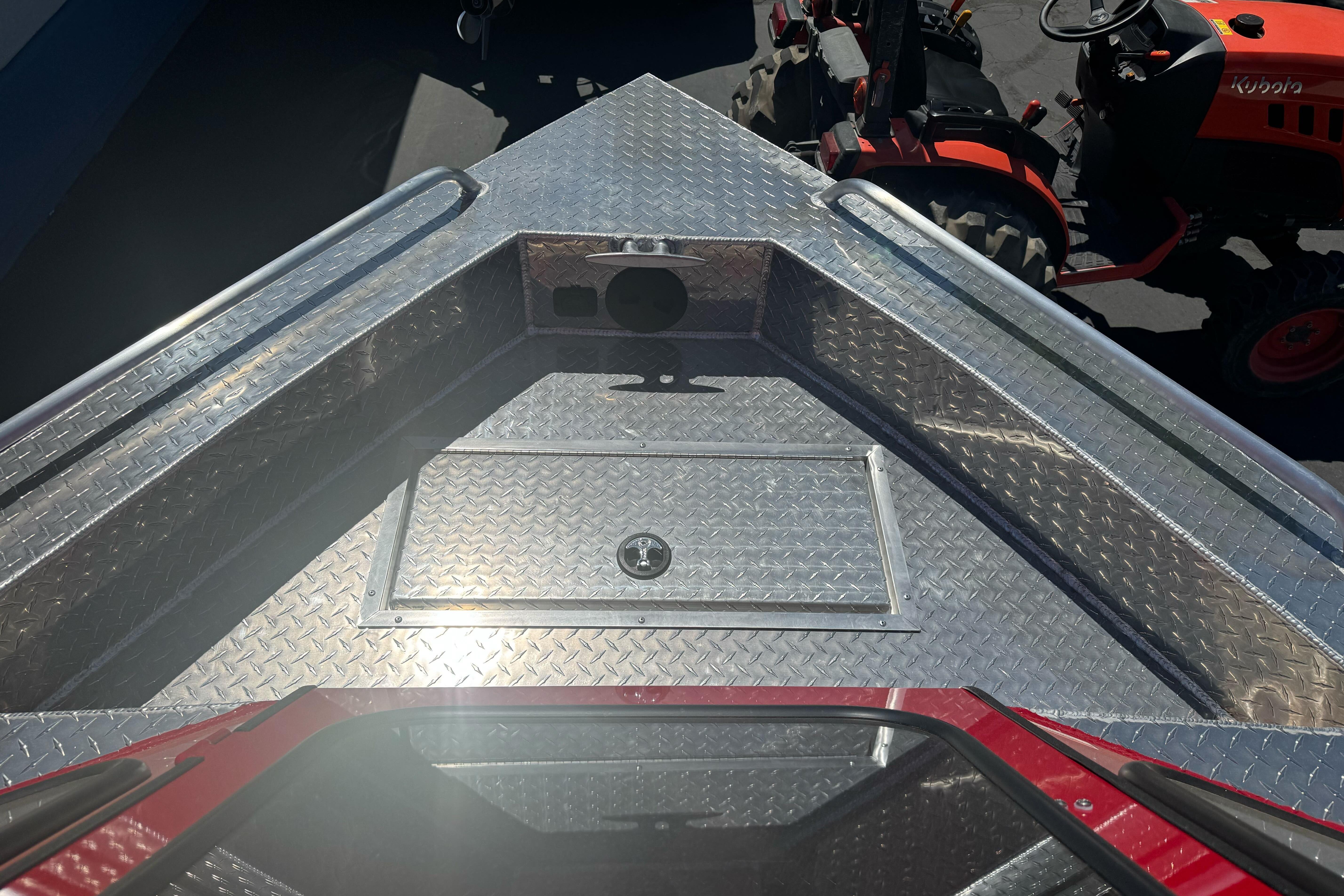 2026 Lund 210 Heavy Gauge boat with diamond plate deck, viewed from above.