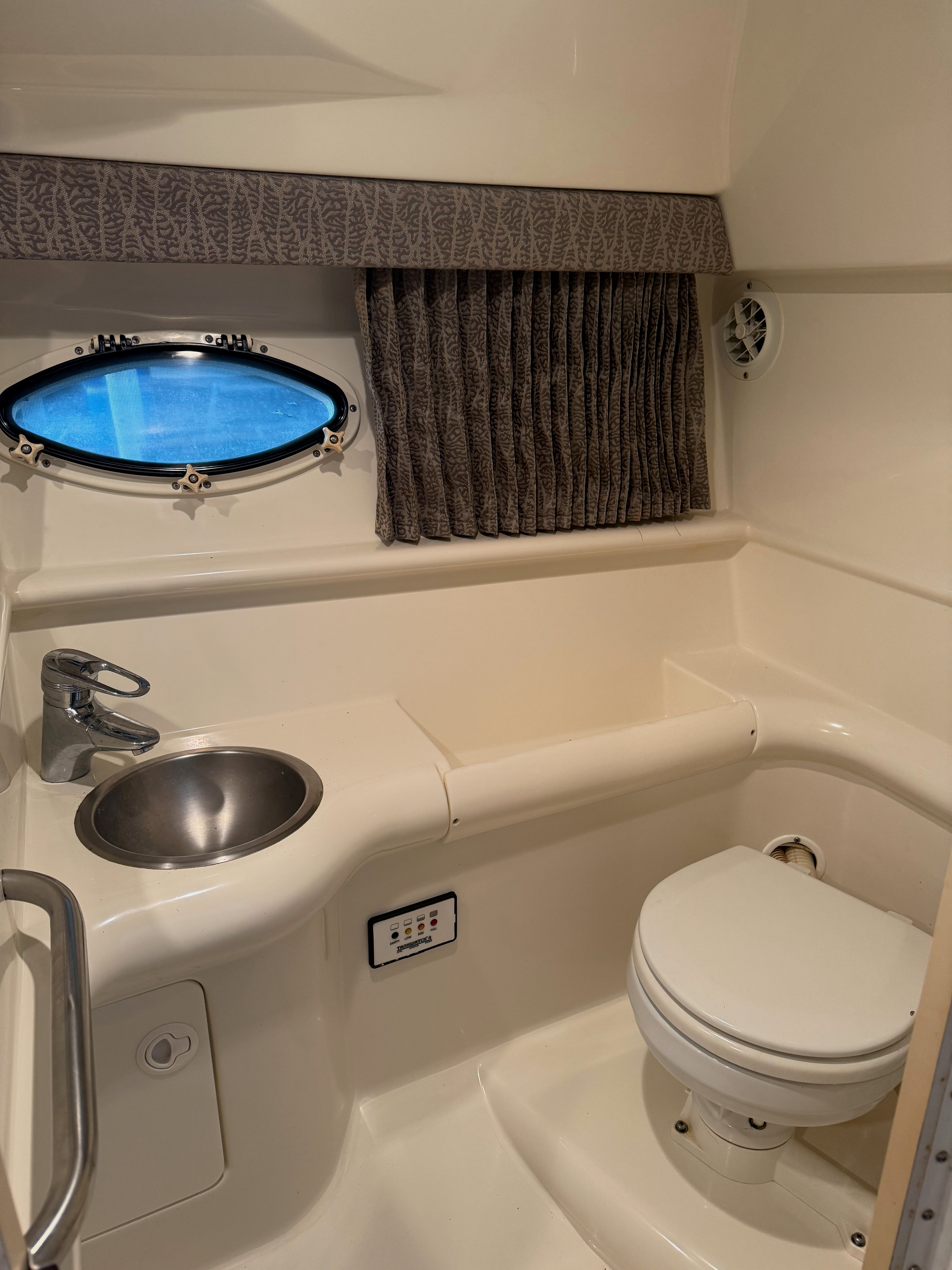 Interior of 2001 Formula 330 Sun Sport yacht with toilet and sink.
