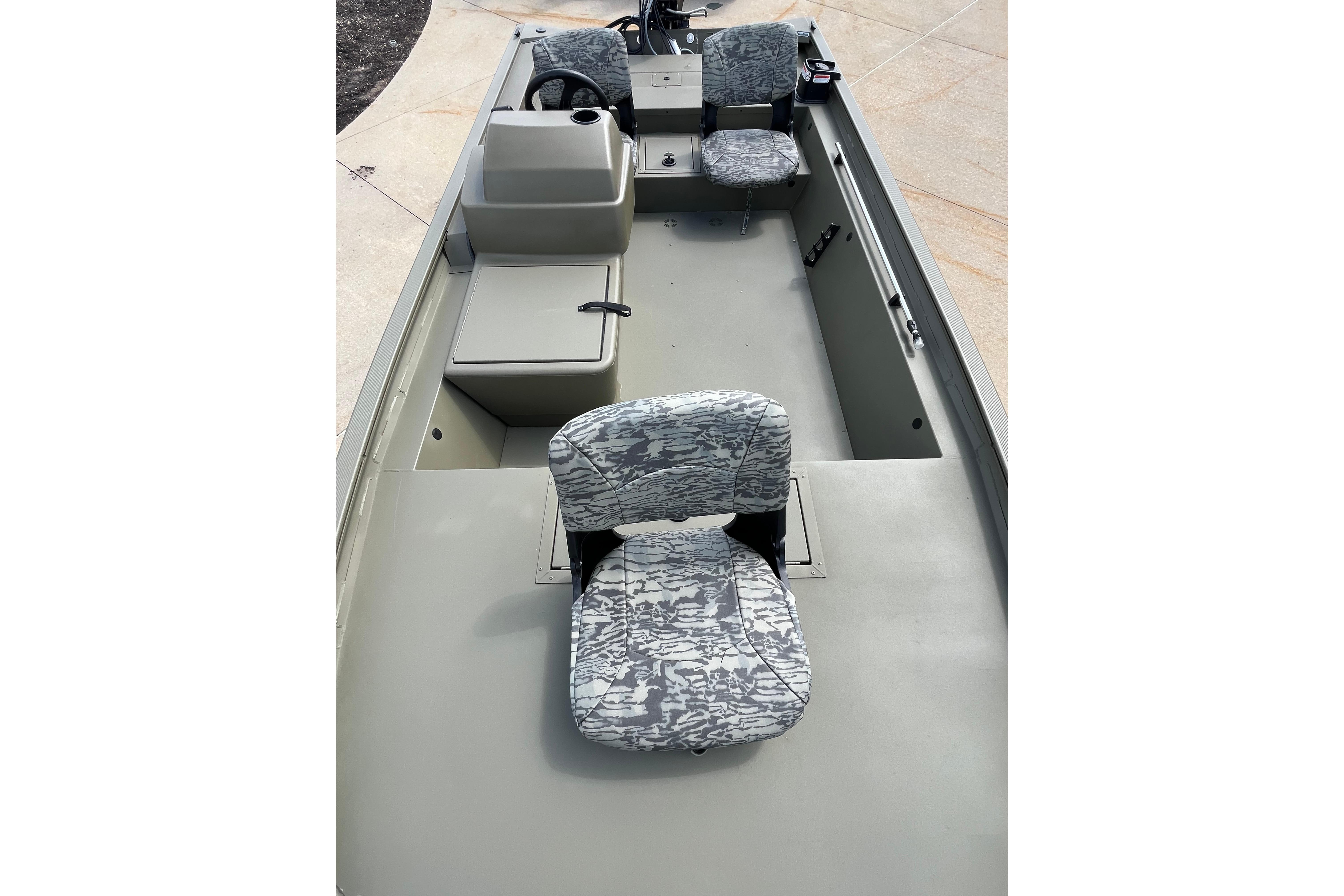 2026 Tracker Grizzly 1754 SC boat interior with camo seats and steering console.