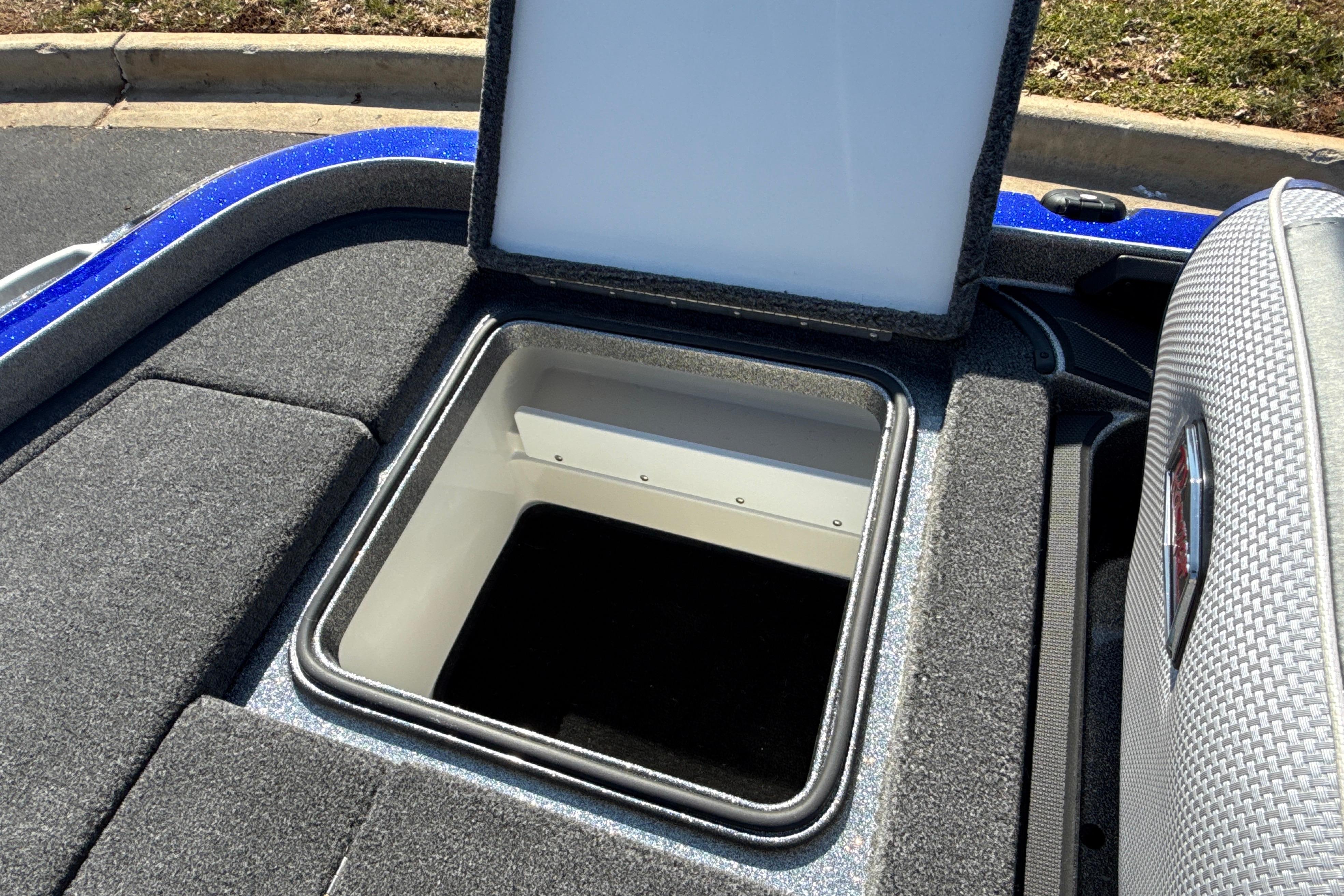 Open storage compartment on 2026 Ranger Z521 boat, featuring carpeted interior and sleek design.