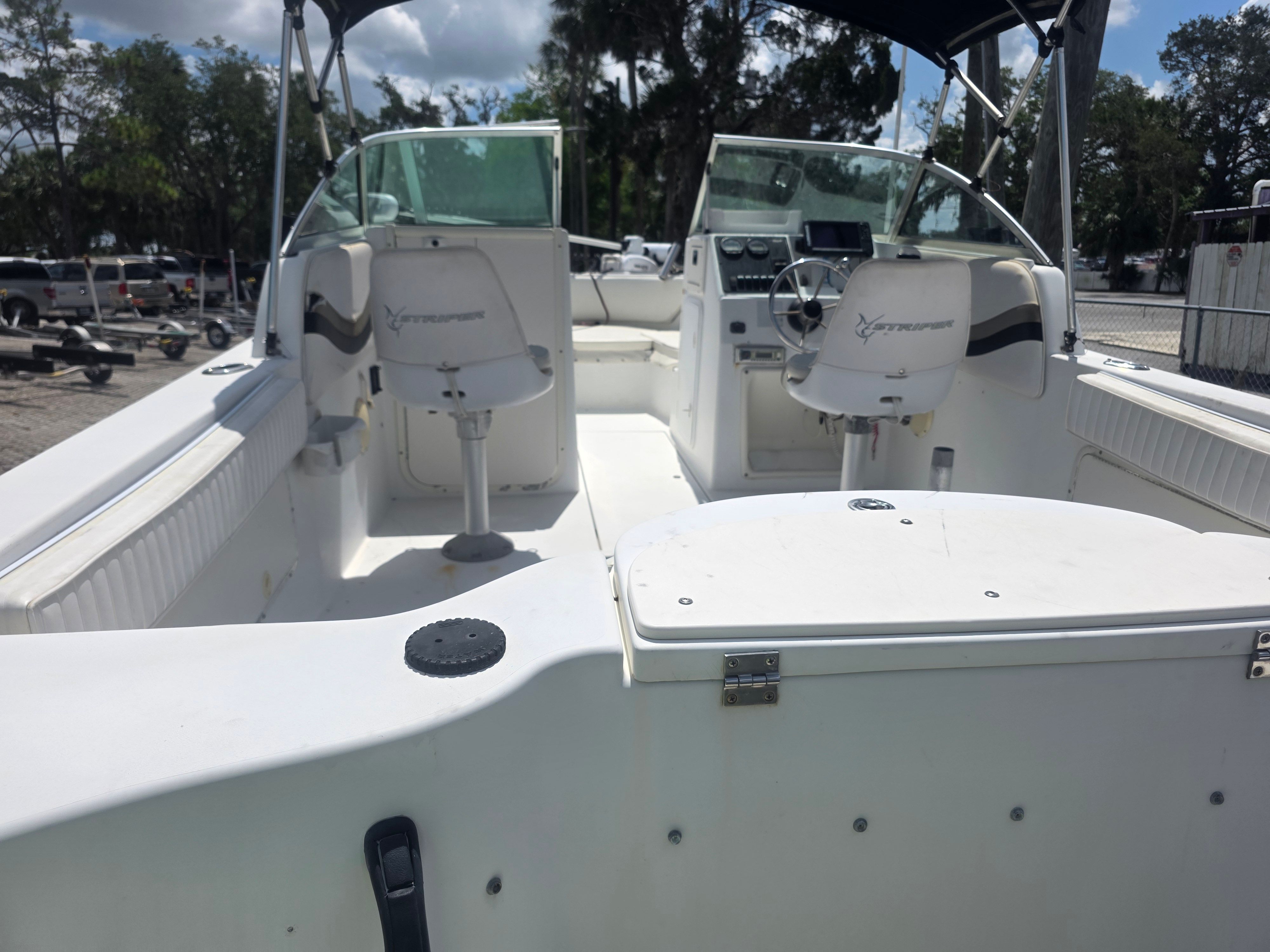 The image shows the cockpit of a 2002 Seaswirl Striper 2101 DC with two seats and a helm.
