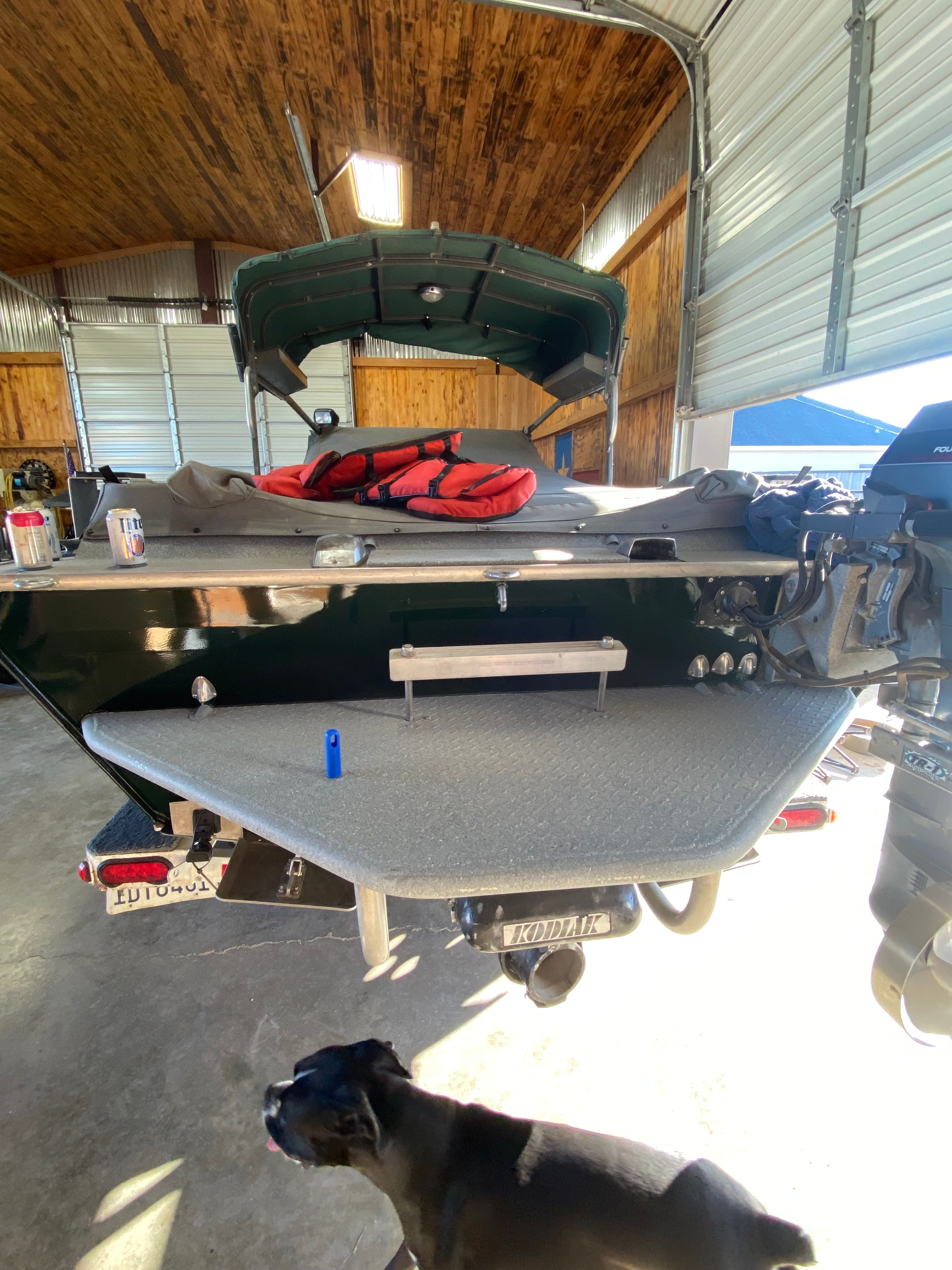 1993 Jetcraft Fastwater boat in garage with dog and equipment.