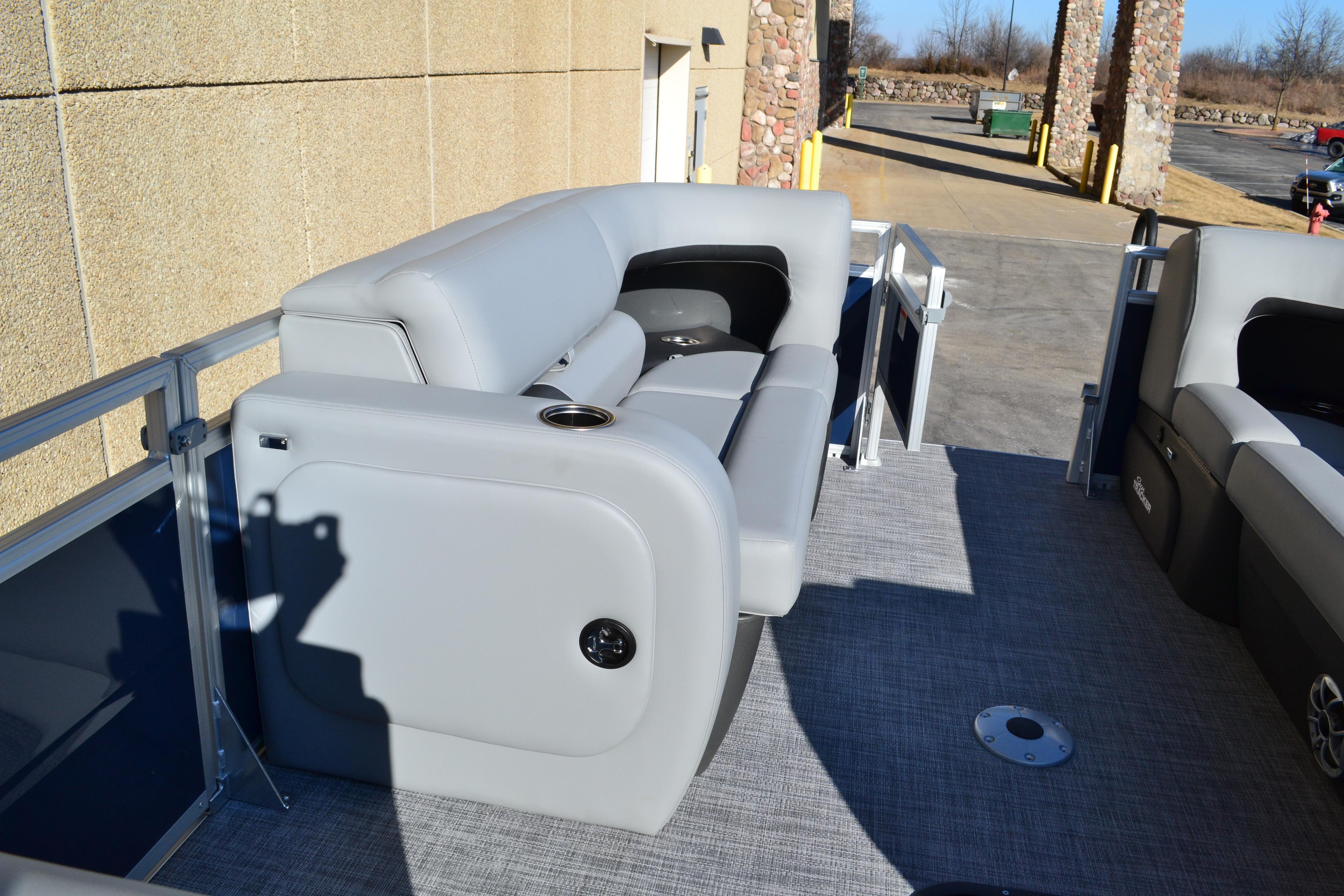 2026 Sun Tracker SportFish 22 XP3 pontoon boat with gray seating and spacious deck.