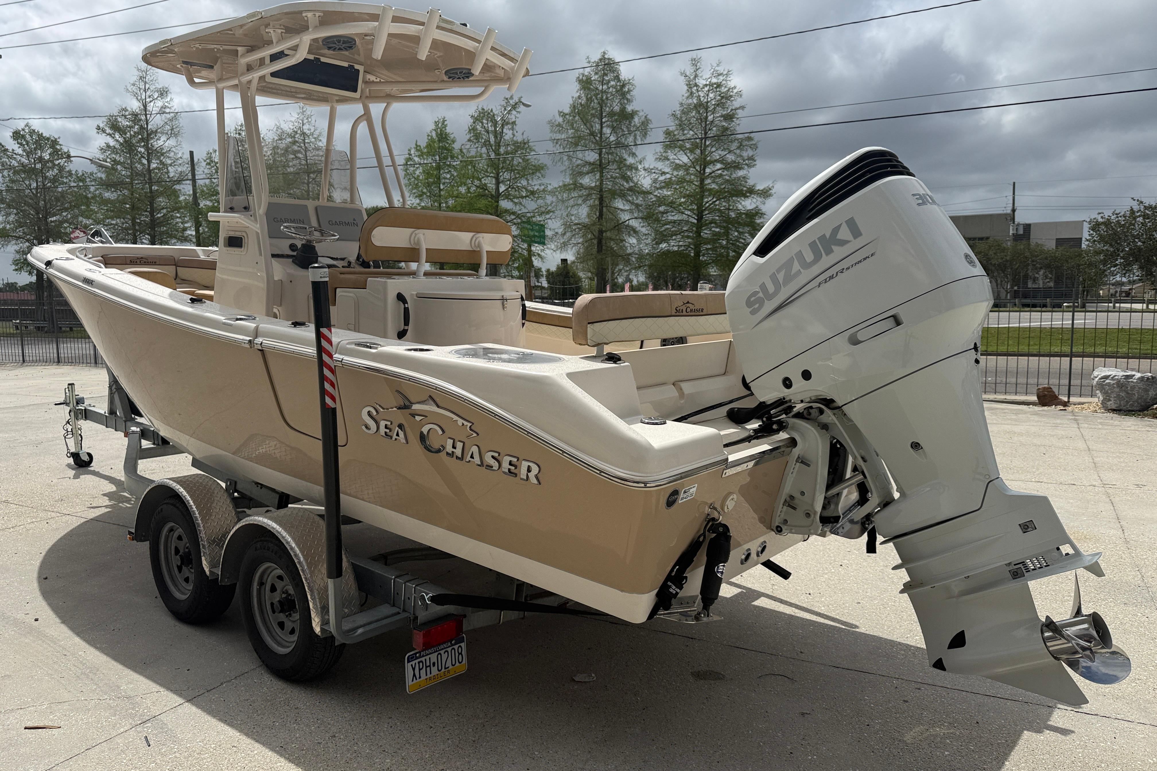 2023 SeaChaser 24 HFC boat with Suzuki outboard motor on a trailer.