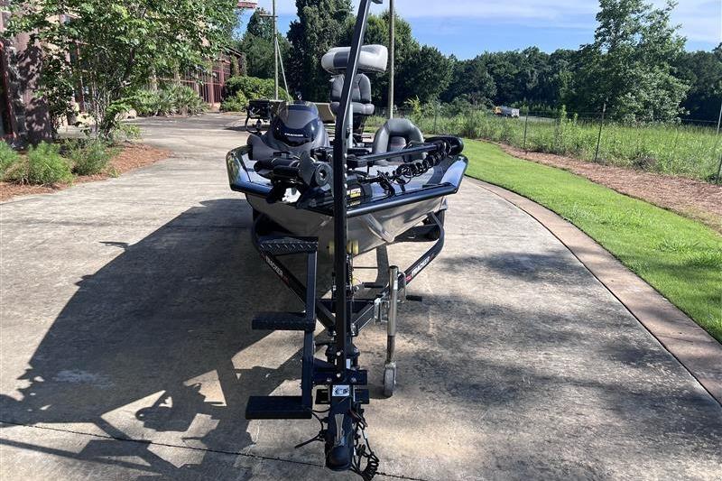 2021 Tracker Pro Team 175 TXW boat on trailer in driveway, surrounded by greenery.