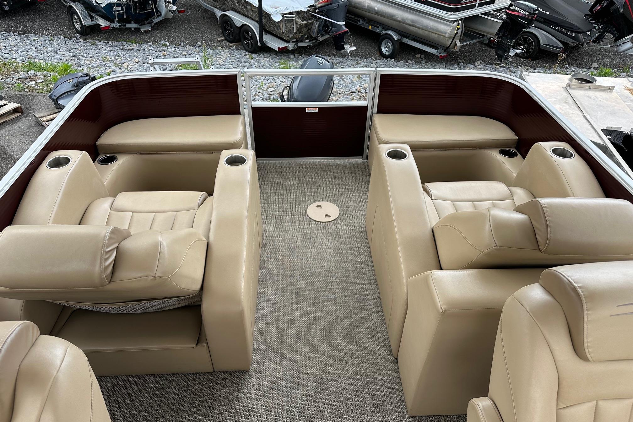 2016 Bennington 24 SCWX pontoon boat interior with beige seating and cup holders.