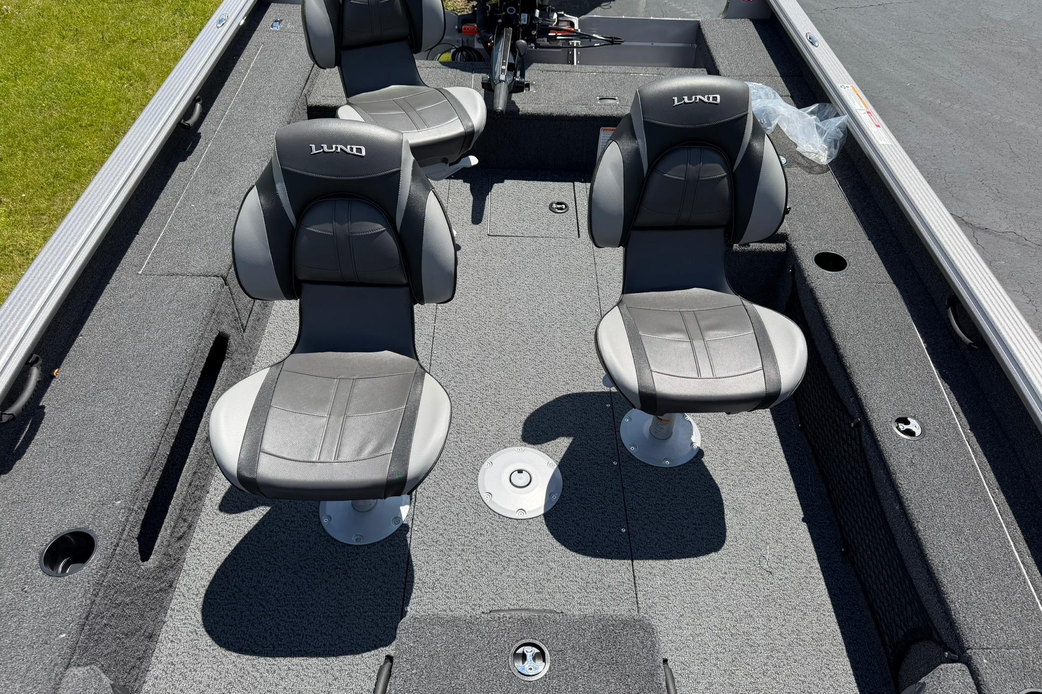 2027 Lund 1875 Pro Guide boat interior with two swivel seats and carpeted flooring.