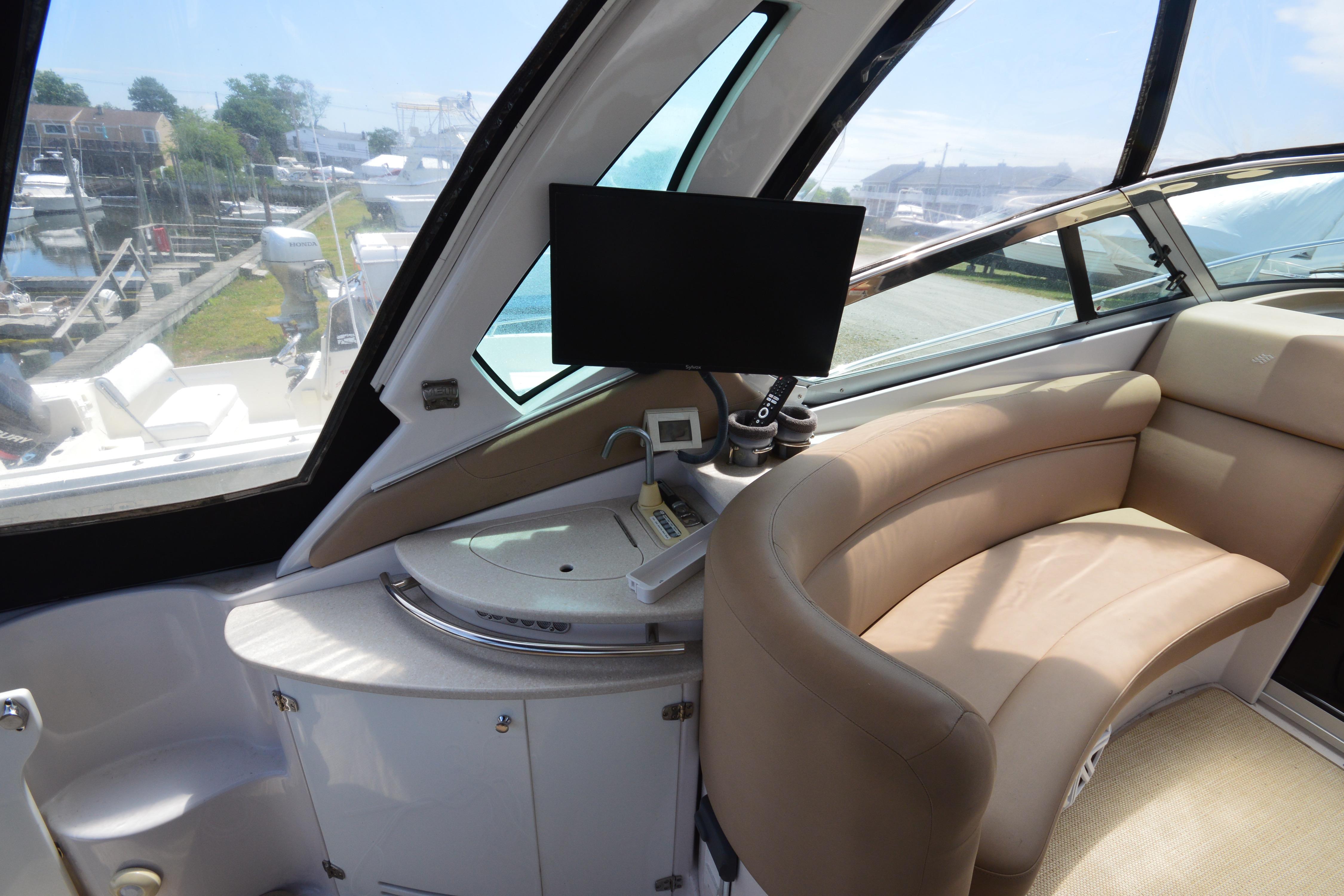 Interior of 2013 Four Winns V375 yacht with curved seating and modern dashboard.