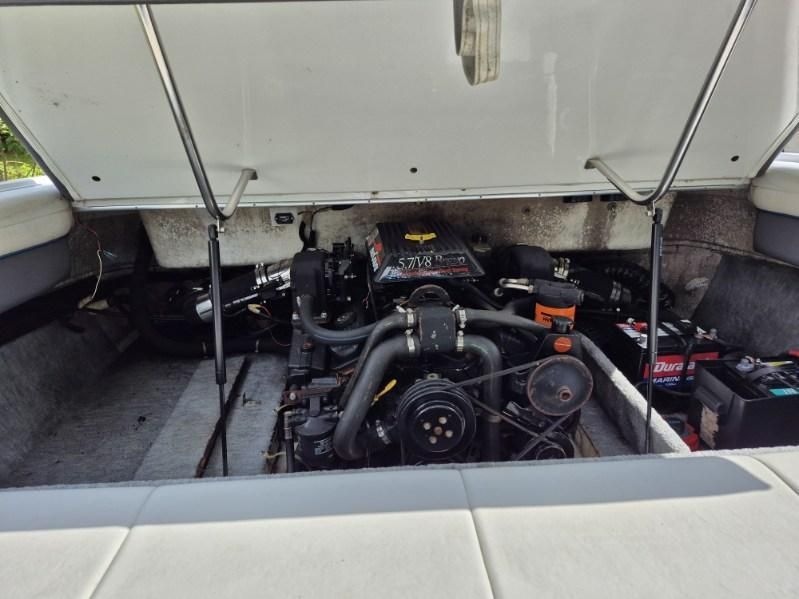 Engine compartment of a 1996 Cobalt 220 boat with open hatch.