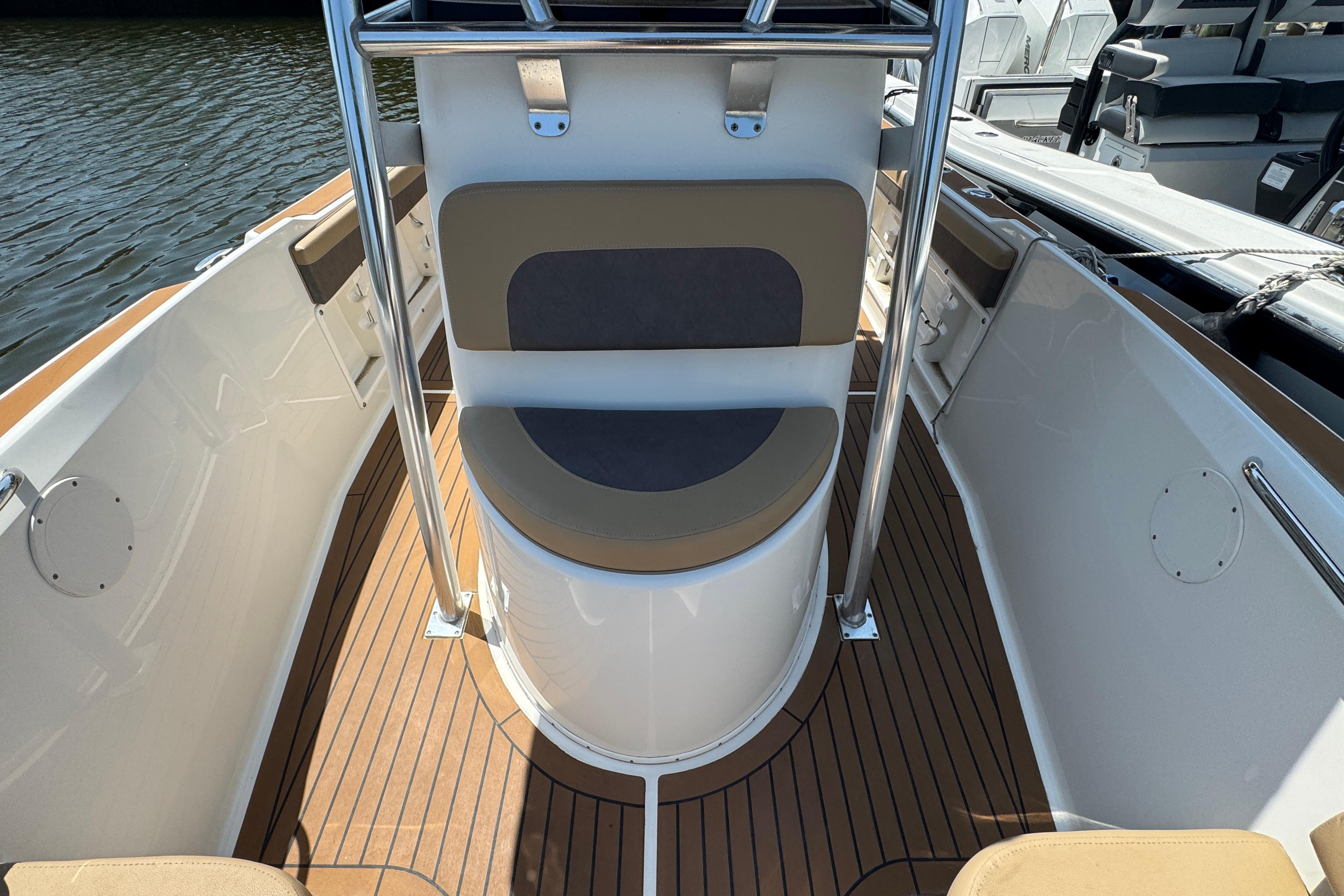 2014 Century 2301 Center Console boat interior with cushioned seating and wood-style flooring.