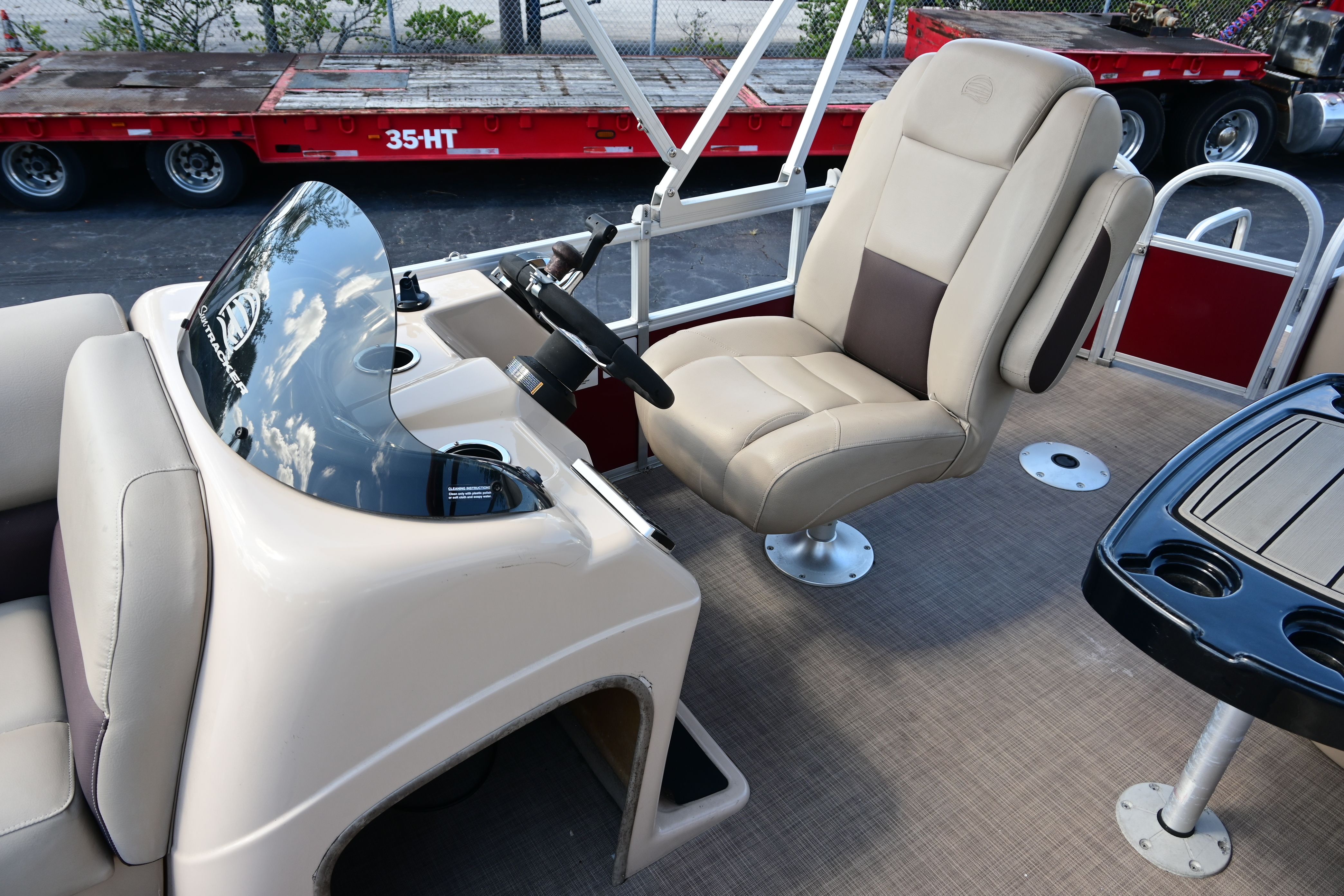 Interior of a 2019 Sun Tracker FISHI boat with steering wheel and seat.