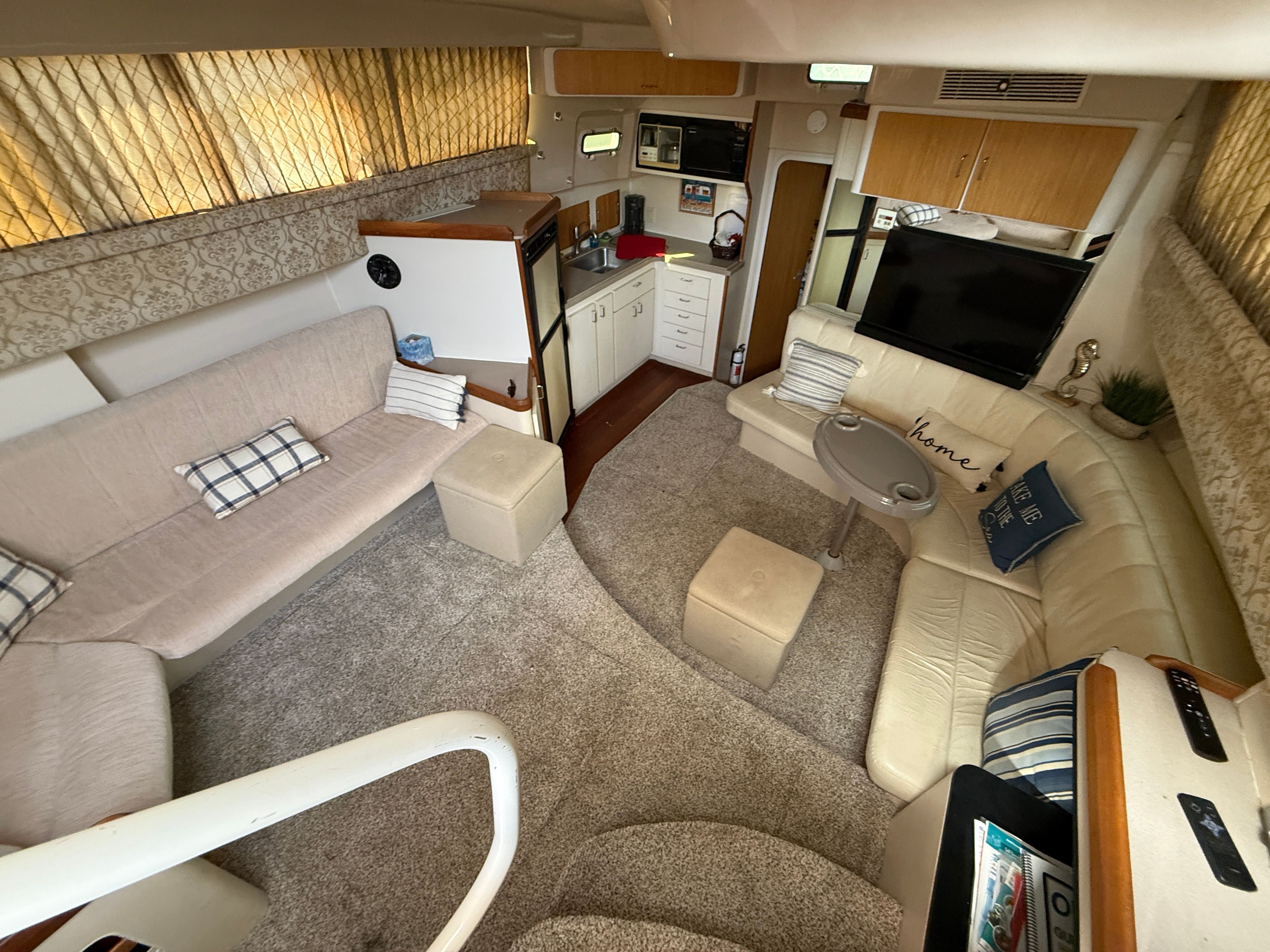 Interior of the 1996 Mainship 37 Motor Yacht with cozy seating and modern amenities.