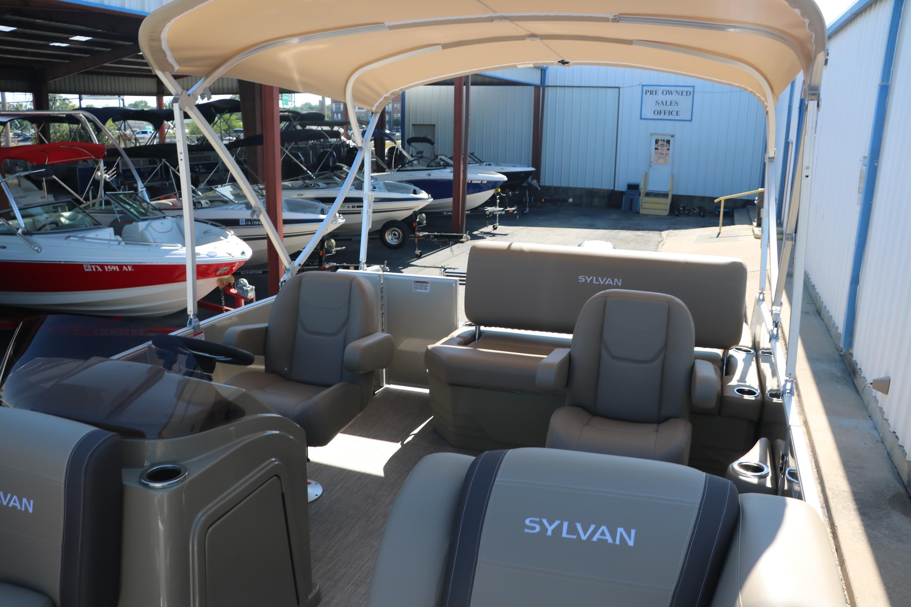 2025 Sylvan Mirage 820 CLZ DH pontoon boat with spacious seating and canopy in a showroom.