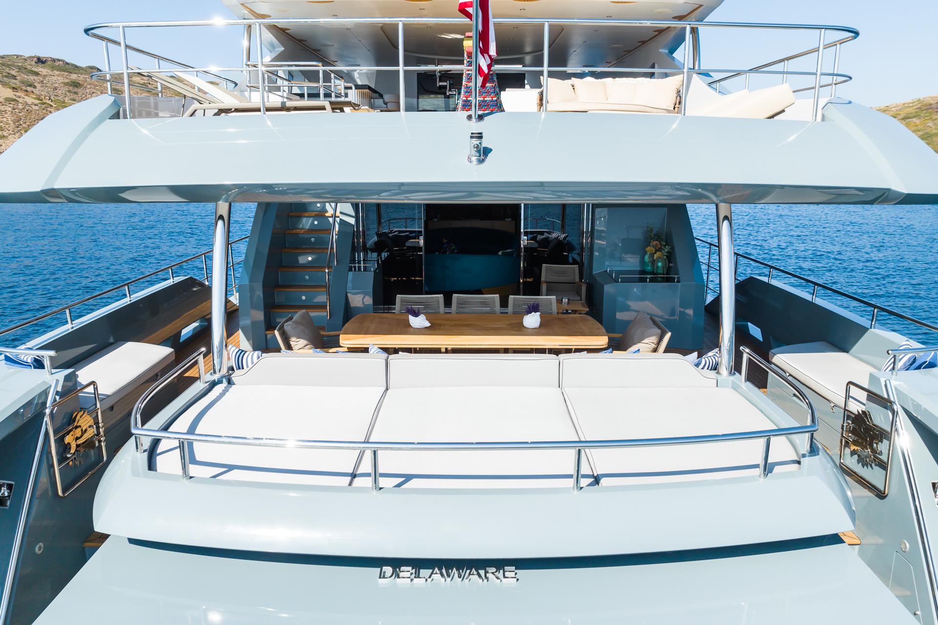 Luxurious 2018 Custom 37 Motoryacht with spacious deck and elegant dining area, docked in serene waters.