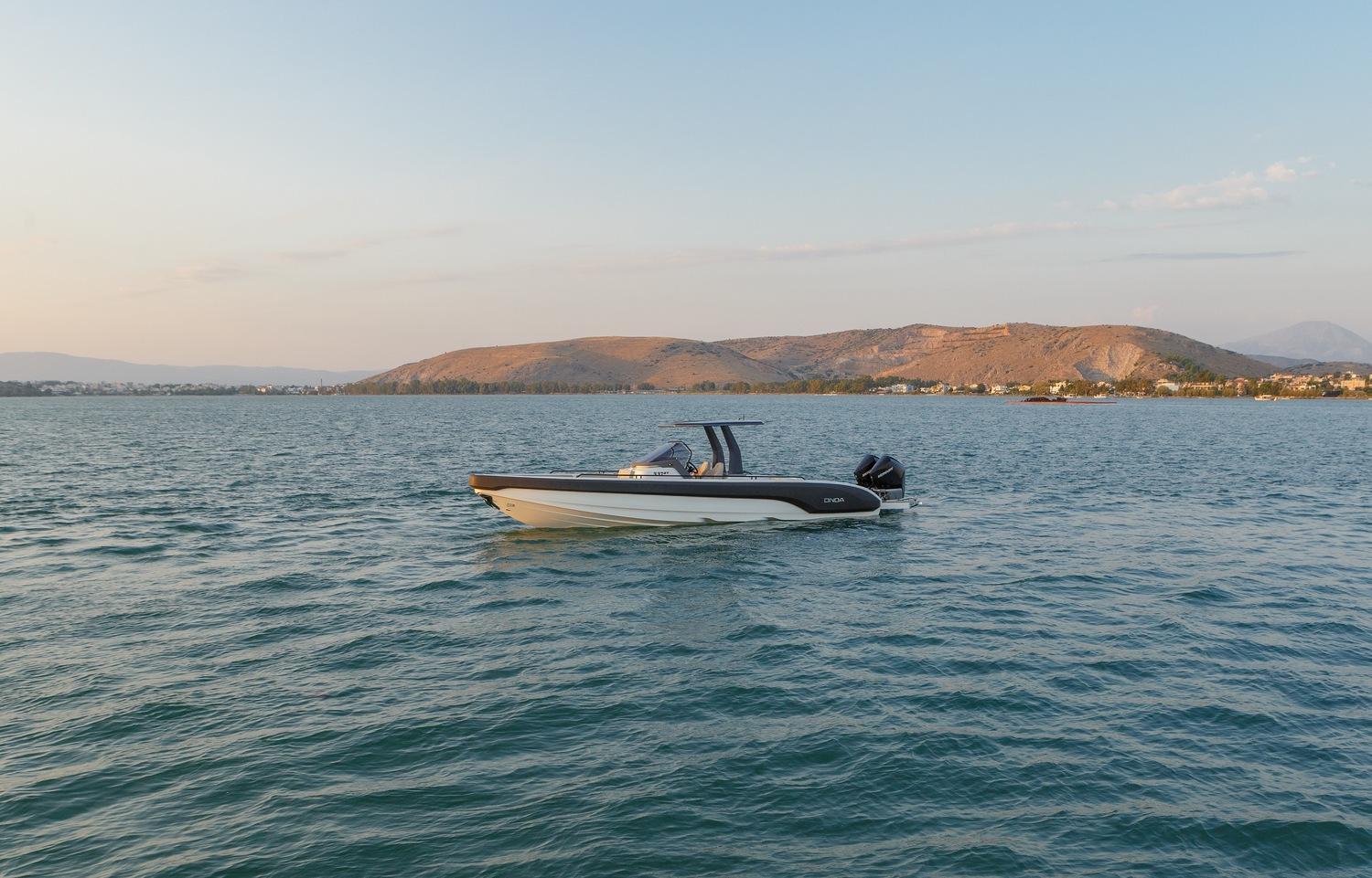 Onda 371GT boat on calm water with scenic hills in the background, 2021 model.