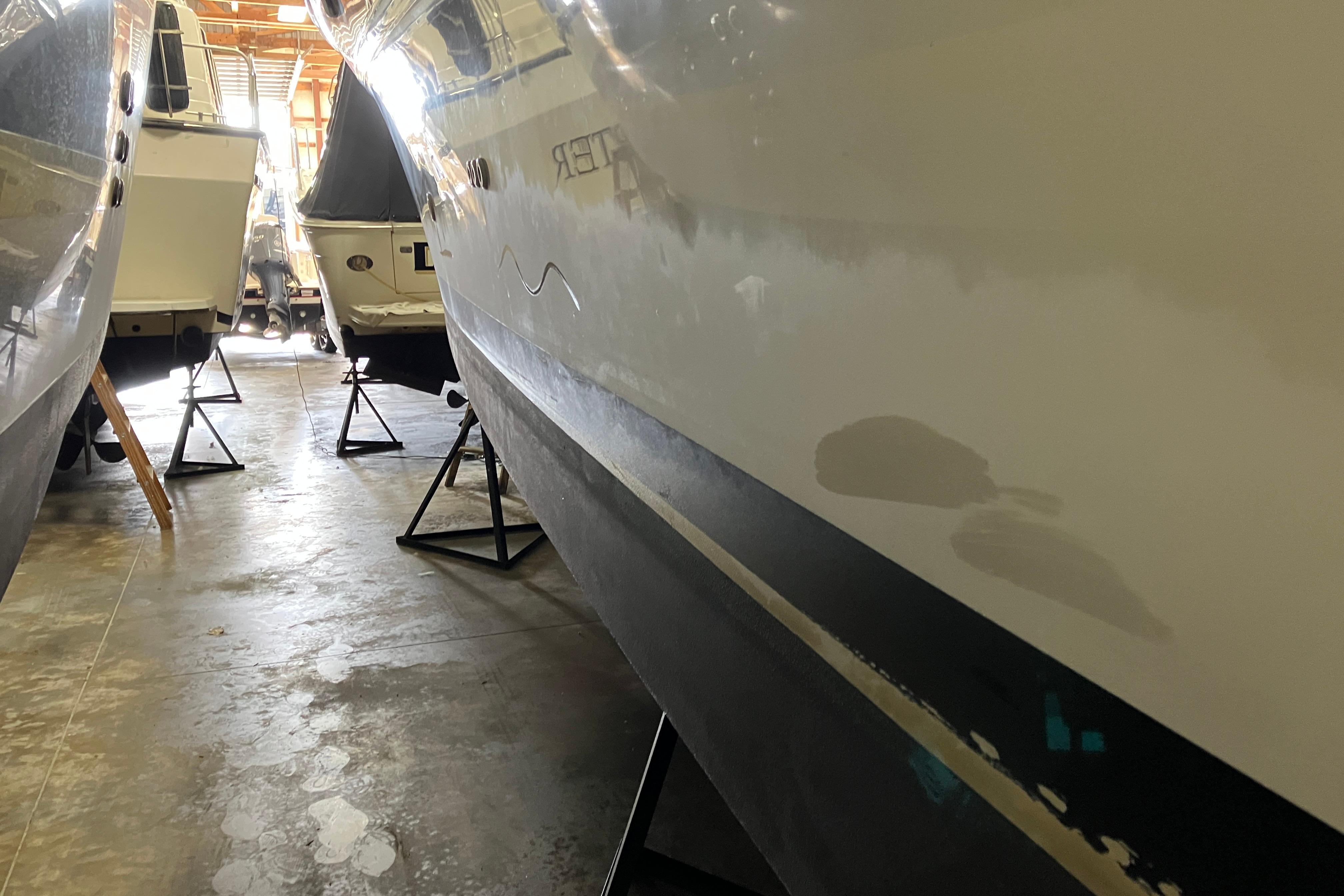 2002 Sea Ray 410 Sundancer in storage, hull view with adjacent boats.