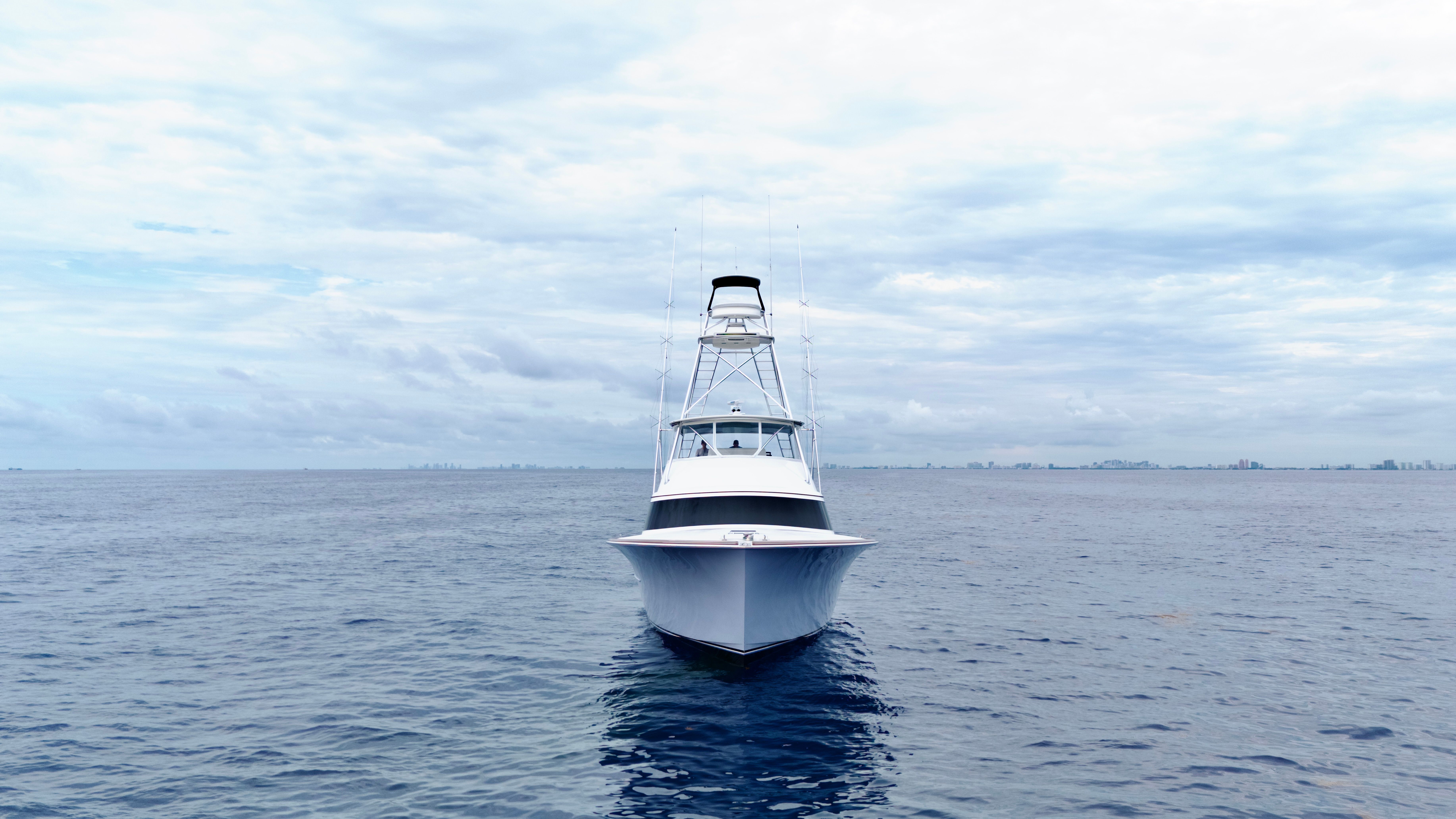 A 2025 Titan Yachts sportfish boat on open water under a cloudy sky.